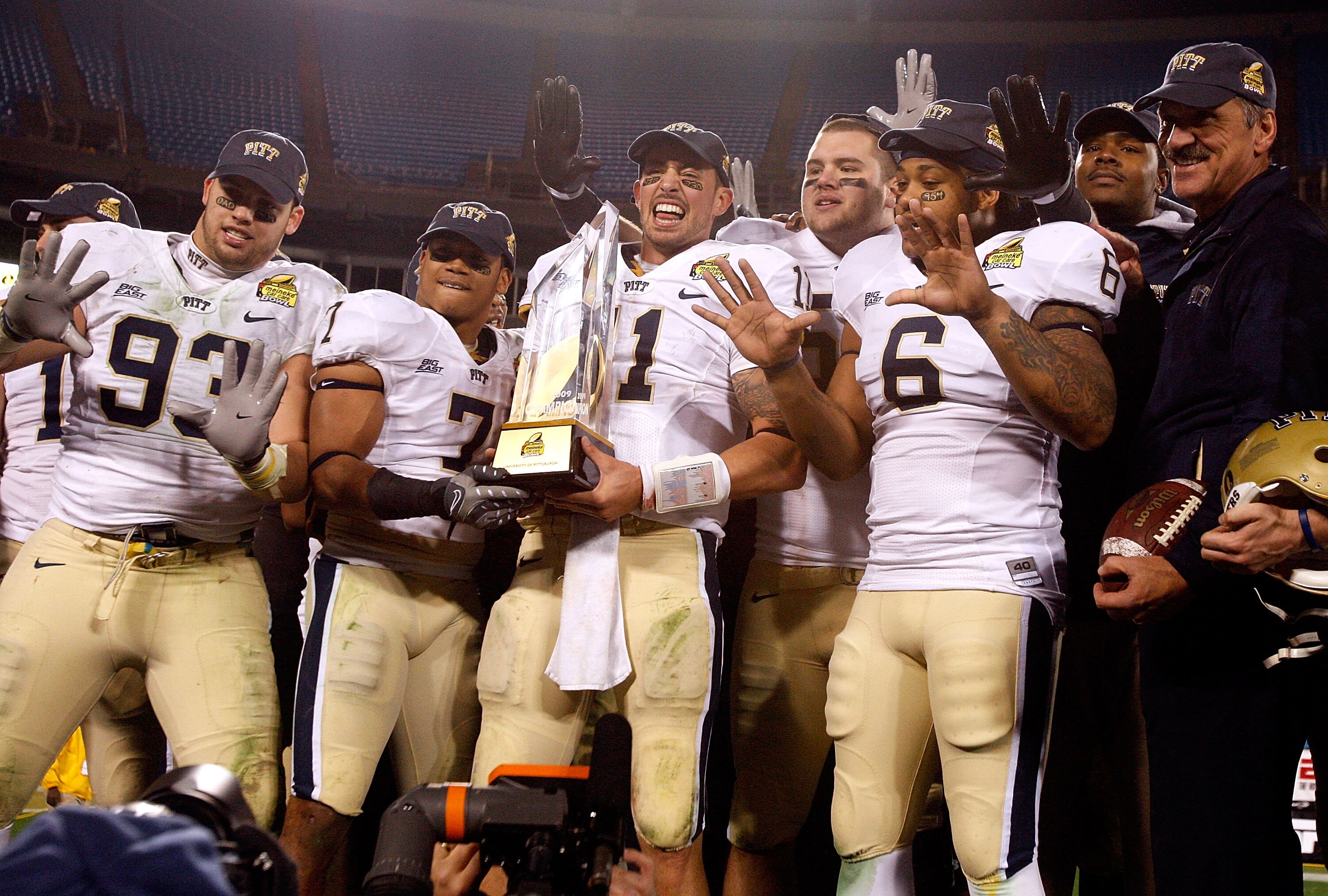 CHARLOTTE, NC - DECEMBER 26:  Bill Stull #11 of the Pittsburgh Panthers and the rest of the Panthers celebrate with head coach Dave Wannstedt after a 19-17 victory over the North Carolina Tar Heels on December 26, 2009 in Charlotte, North Carolina.  (Phot