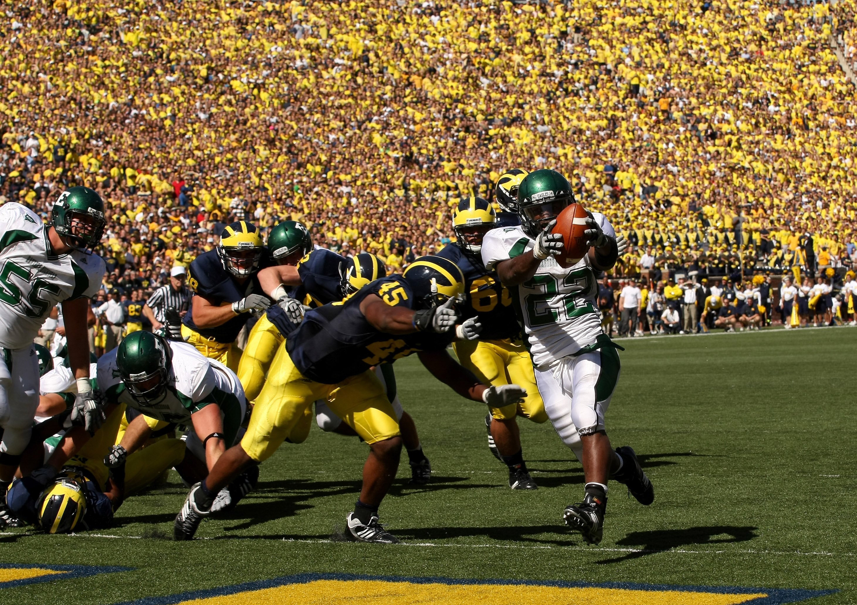 ANN ARBOR, MI - SEPTEMBER 19:  Running back Dwayne Priest #22 of the Eastern Michigan Eagles celebrates as he scores on a  five yard touchdown run in the second quarter against the Michigan Wolverines  at Michigan Stadium on September 19, 2009 in Ann Arbo
