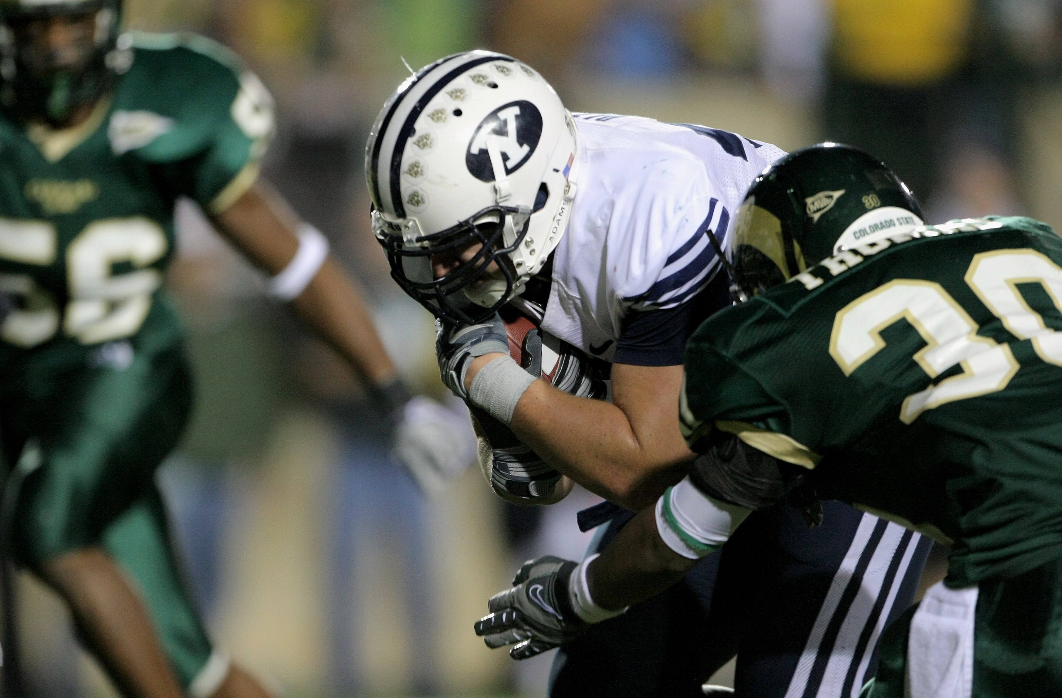 FORT COLLINS, CO - NOVEMBER 01:  Dennis Pitta #32 of the Brigham Young Cougars lunges into the endzone with his game winning 17 yard touchdown with :22 seconds remaining as Gerard Thomas #30 of the Colorado State Rams defends at Sonny Lubick Field at Hugh