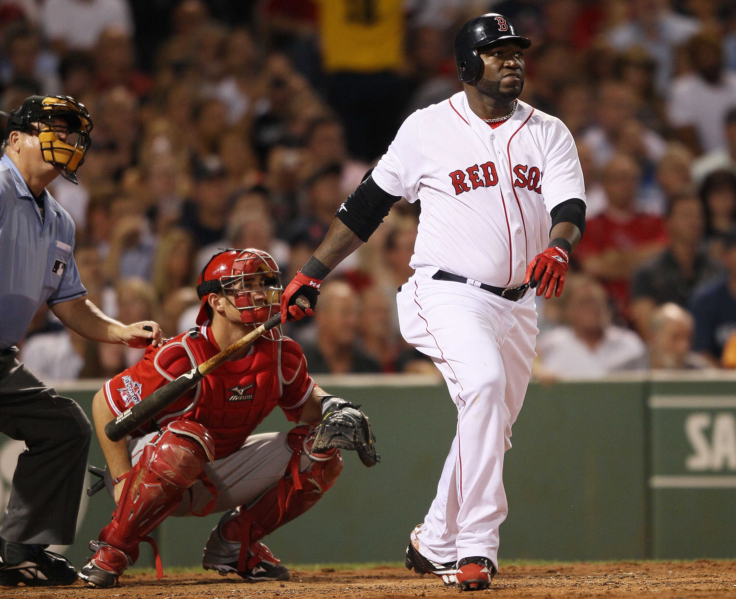 BOSTON - AUGUST 19:  David Ortiz #34  of the Boston Red Sox hits a solo home run in the fourth inning as Jeff Mathis #5 of the Los Angeles Angels of Anaheim defends on August 19, 2010 at Fenway Park in Boston, Massachusetts.  (Photo by Elsa/Getty Images)