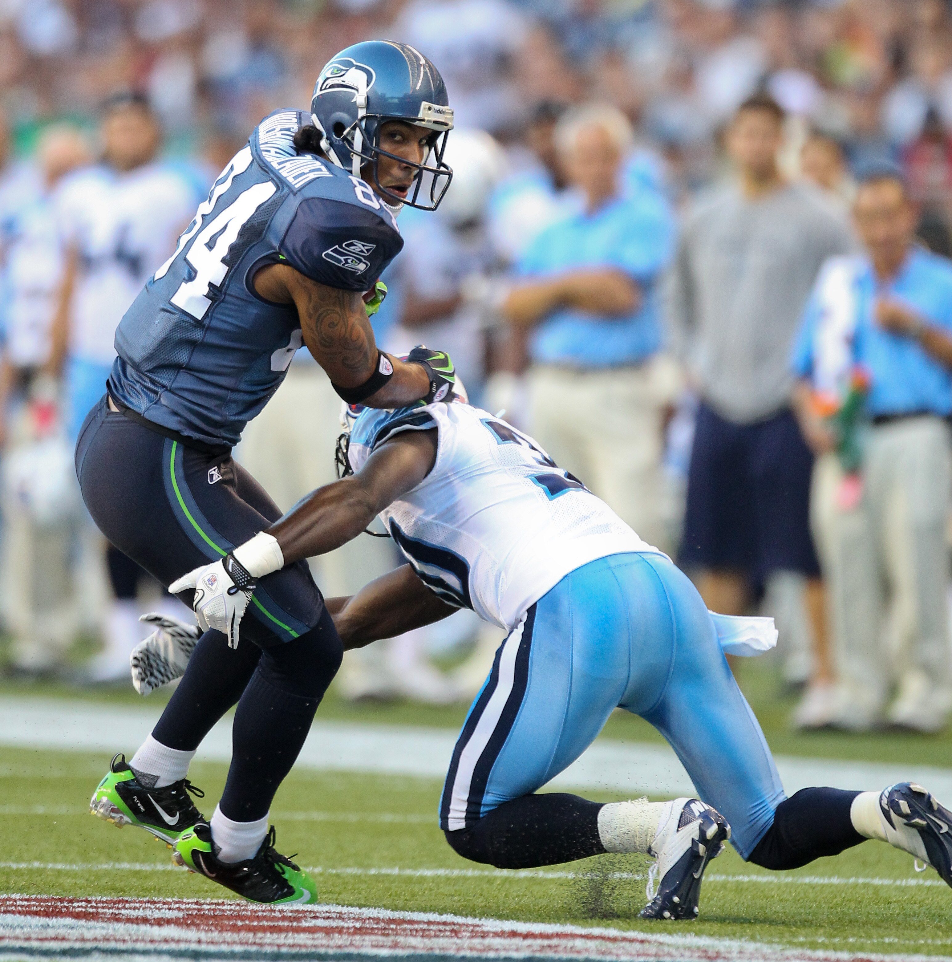 SEATTLE - AUGUST 14:  Wide receiver T.J. Houshmandzadeh #84 of the Seattle Seahawks rushes during the preseason game against Jason McCourty #30 of the Tennessee Titans at Qwest Field on August 14, 2010 in Seattle, Washington. (Photo by Otto Greule Jr/Gett