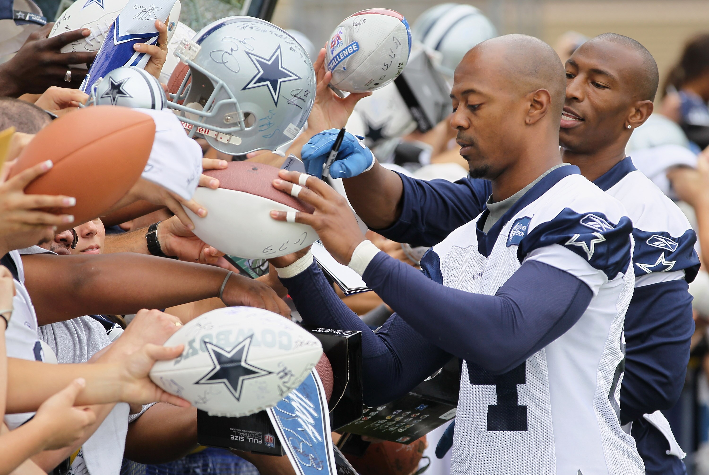 OXNARD, CA - AUGUST 14:  Wide receivers Patrick Crayton (L) #84 and Sam Hurd #17 sign autographs for fans during Dallas Cowboys Training Camp at the Marriott Residence Inn Oxnard River Ridge on August 14, 2010 in Oxnard, California.  (Photo by Jeff Gross/
