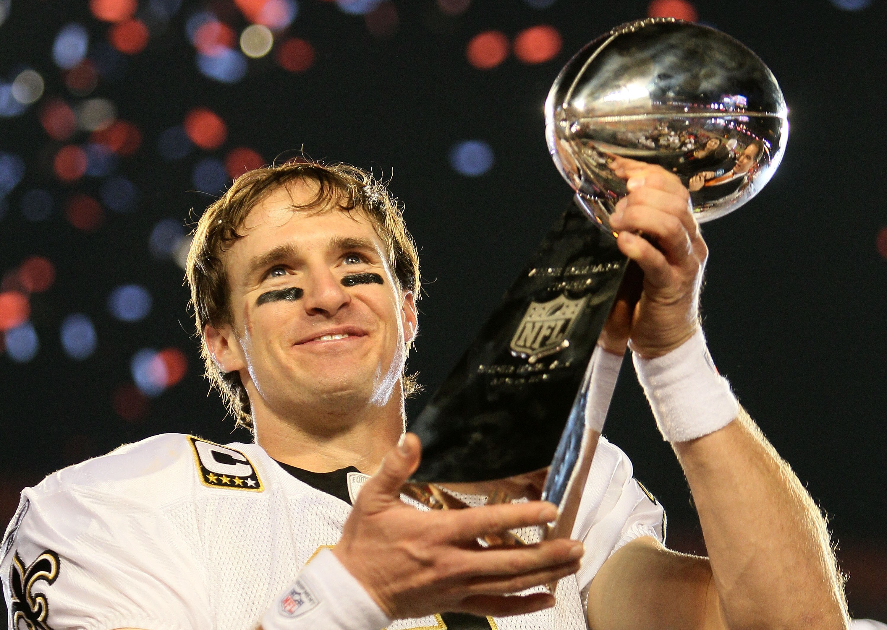 MIAMI GARDENS, FL - FEBRUARY 07: Drew Brees #9 of the New Orleans Saints holds up the Vince Lombardi Trophy after defeating the Indianapolis Colts during Super Bowl XLIV on February 7, 2010 at Sun Life Stadium in Miami Gardens, Florida.  (Photo by Andy Ly