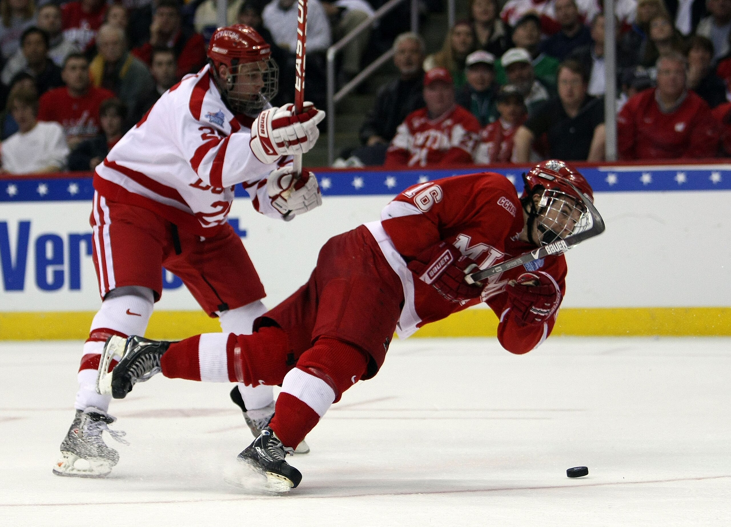 WASHINGTON - APRIL 11:  Justin Mercier #16 of the Miami Red Hawks takes a shot as he is shoved by Colby Cohen #25 of the Boston Terriers during the NCAA Men's Frozen Four Championship game on April 11, 2009 at the Verizon Center in Washington, DC.  (Photo