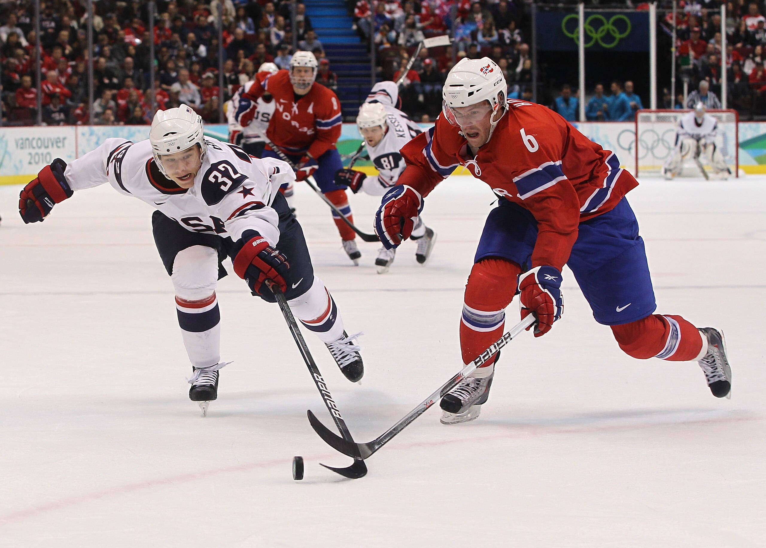 VANCOUVER, BC - FEBRUARY 18:  Dustin Brown (#32) of the United States battles Jonas Holos of Norway during the ice hockey men's preliminary game between USA and Norway on day 7 of the 2010 Winter Olympics at Canada Hockey Place on February 18, 2010 in Van