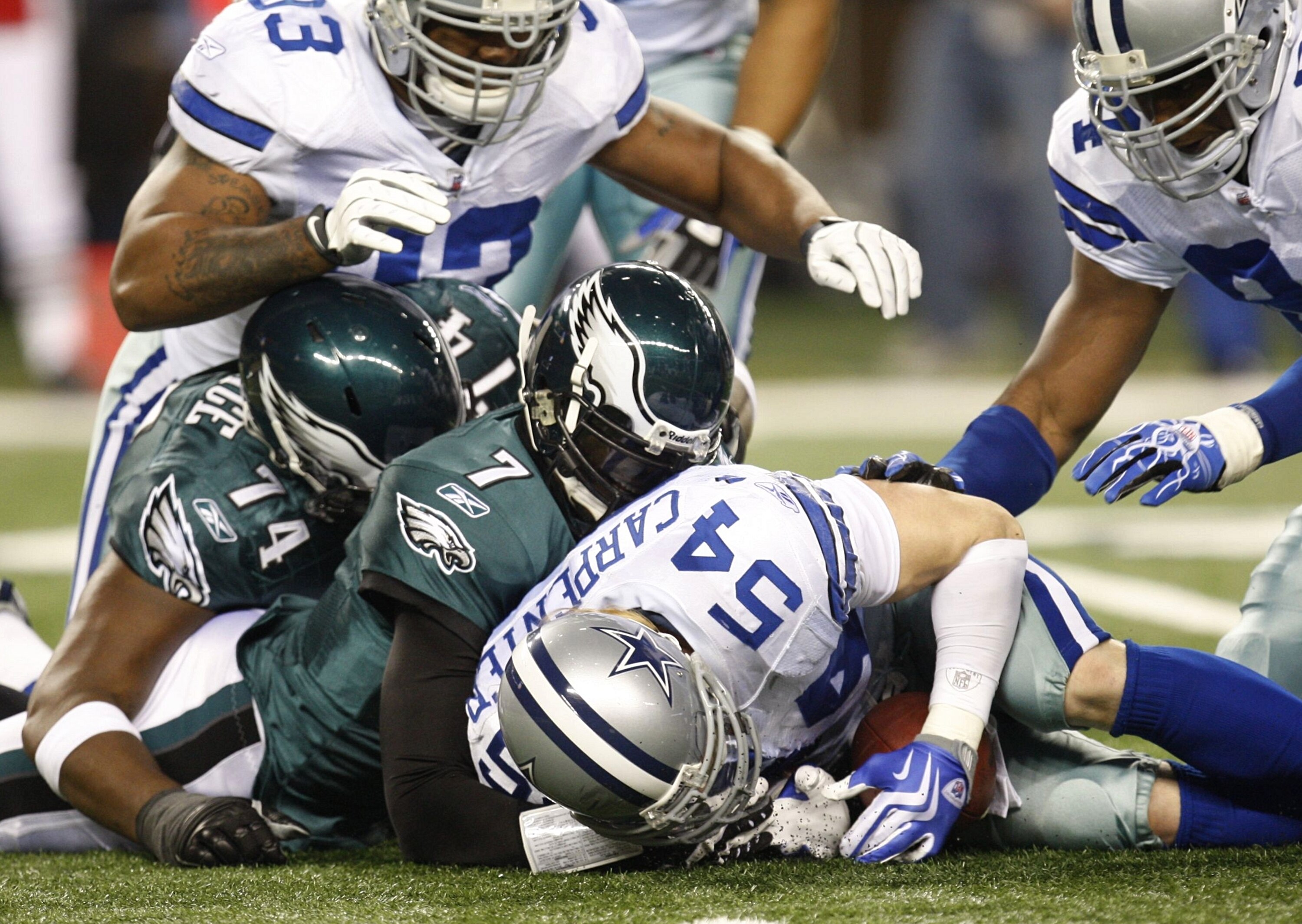 ARLINGTON, TX - JANUARY 9:  Linebacker Bobby Carpenter #54 of the Dallas Cowboys recovers a fumble by quarterback Michael Vick #7 of the Philadelphia Eagles during the 2010 NFC wild-card playoff game at Cowboys Stadium on January 9, 2010 in Arlington, Tex