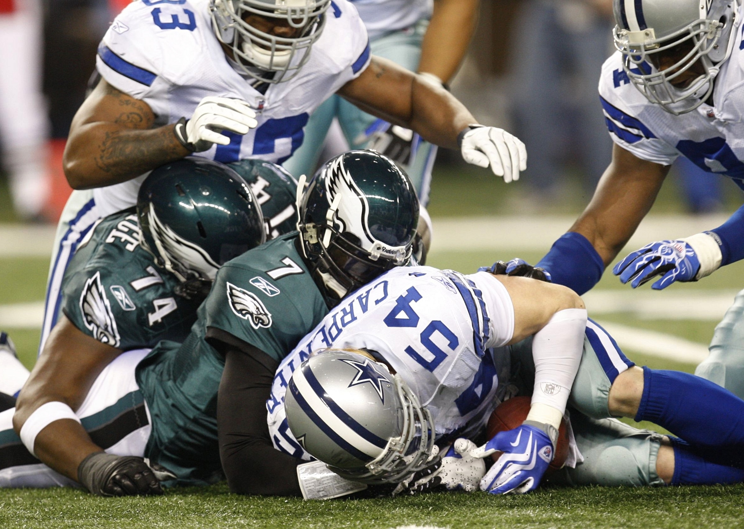 ARLINGTON, TX - JANUARY 9:  Linebacker Bobby Carpenter #54 of the Dallas Cowboys recovers a fumble by quarterback Michael Vick #7 of the Philadelphia Eagles during the 2010 NFC wild-card playoff game at Cowboys Stadium on January 9, 2010 in Arlington, Tex