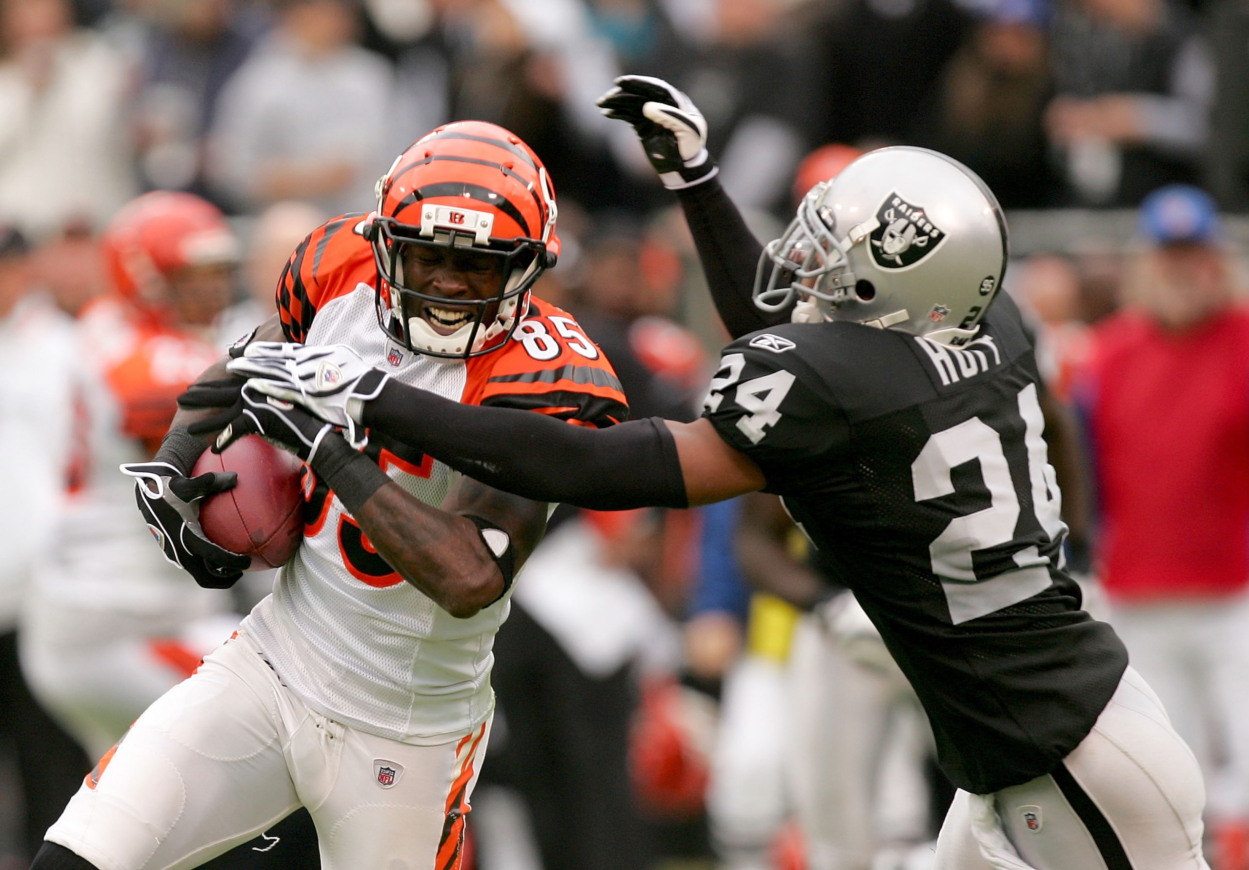 OAKLAND, CA - NOVEMBER 22:  Chad Ochocinco #85 of the Cincinnati Bengals is tackled by Michael Huff #24 of the Oakland Raiders at Oakland-Alameda County Coliseum on November 22, 2009 in Oakland, California.  (Photo by Ezra Shaw/Getty Images)