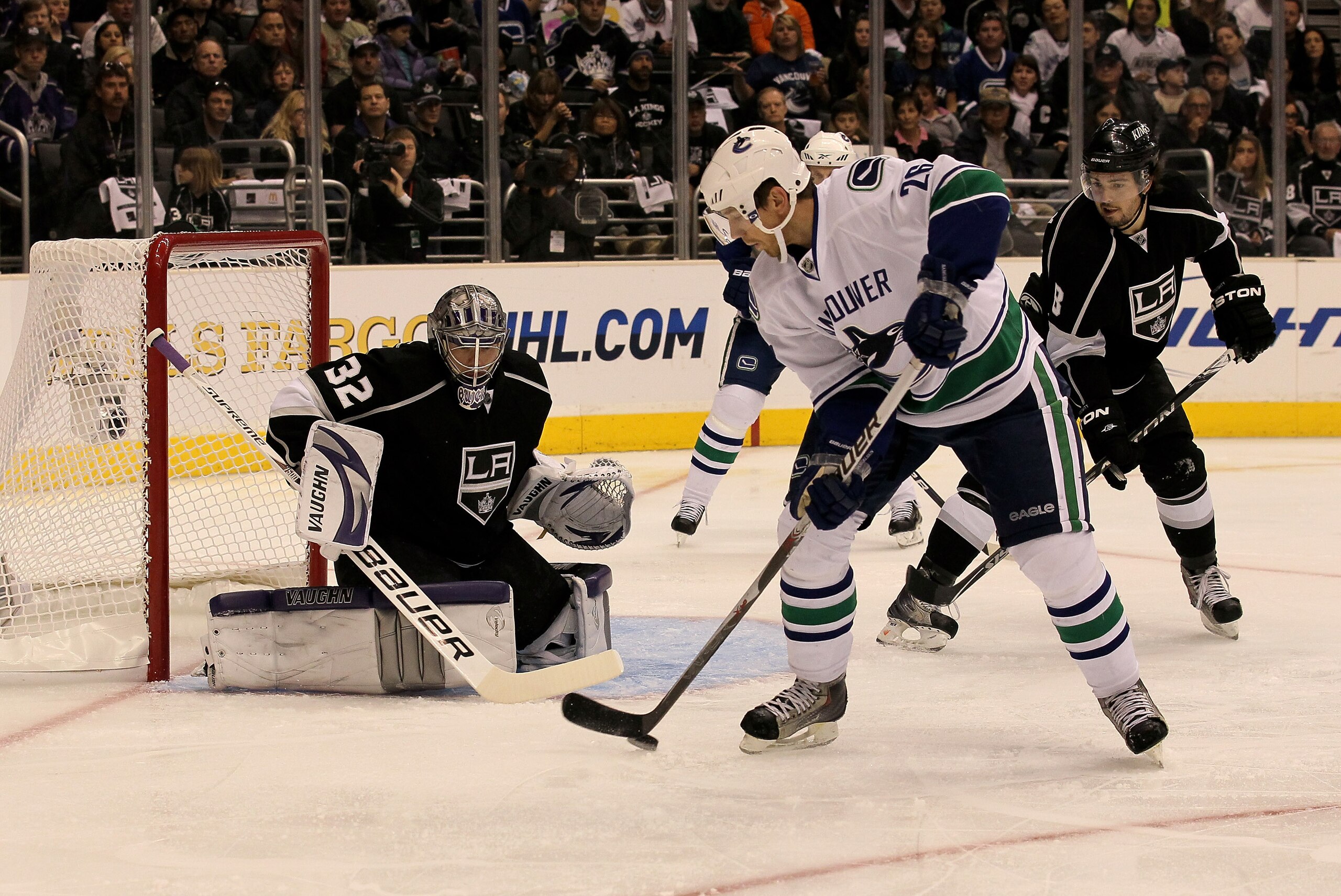 LOS ANGELES - APRIL 25: Mikael Samuelsson #26 of the Vancouver Canucks handles the puck in front of goaltender Jonathan Quick #32 of the Los Angeles Kings during Game Six of the Western Conference Quarterfinals of the 2010 NHL Stanley Cup Playoffs on Apr LOS ANGELES - APRIL 25: Mikael Samuelsson #26 of the Vancouver Canucks handles the puck in front of goaltender Jonathan Quick #32 of the Los Angeles Kings during Game Six of the Western Conference Quarterfinals of the 2010 NHL Stanley Cup Playoffs on Apr