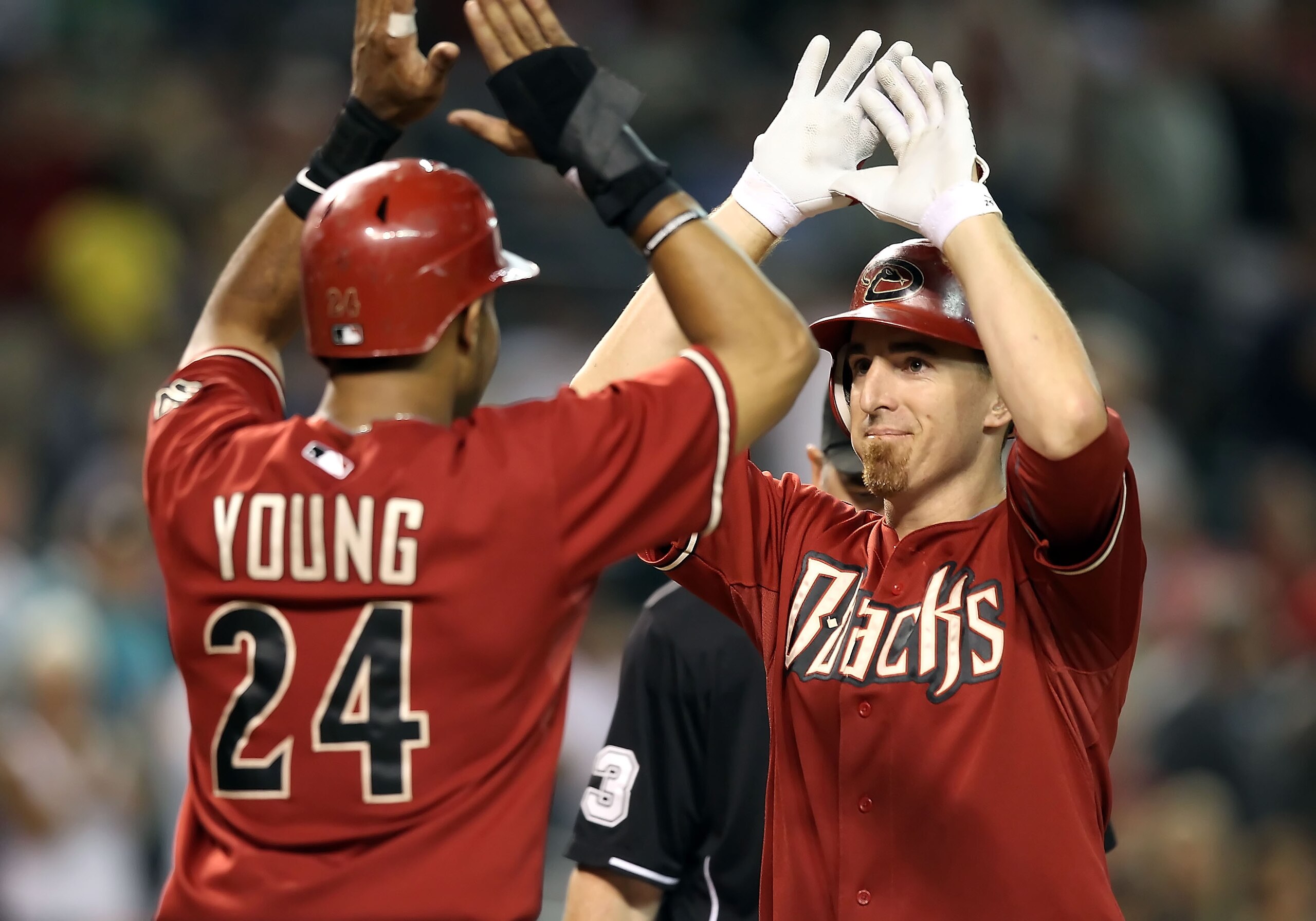 PHOENIX - AUGUST 18:  Adam LaRoche #25 of the Arizona Diamondbacks is congratulated by teammate Justin Upton #10 after LaRoche hit a 2 run home run against the Cincinnati Reds during the seventh inning of the Major League Baseball game at Chase Field on A