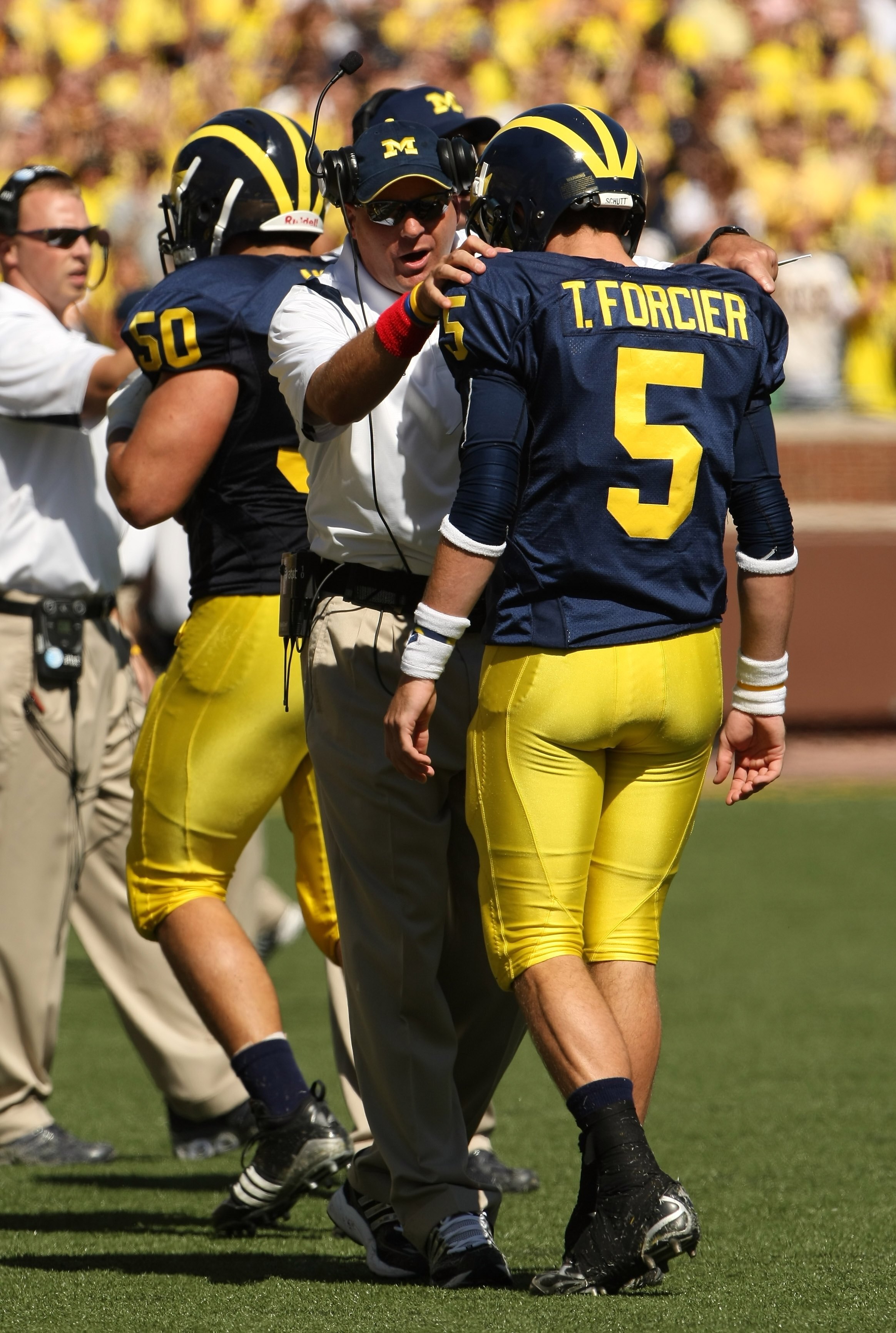 ANN ARBOR, MI - SEPTEMBER 19:  Head coach Rich Rodriguez of the Michigan Wolverines talks with quarterback Tate Forcier #5 during the game with the Eastern Michigan Eagles at Michigan Stadium on September 19, 2009 in Ann Arbor, Michigan.  Michigan won 45-