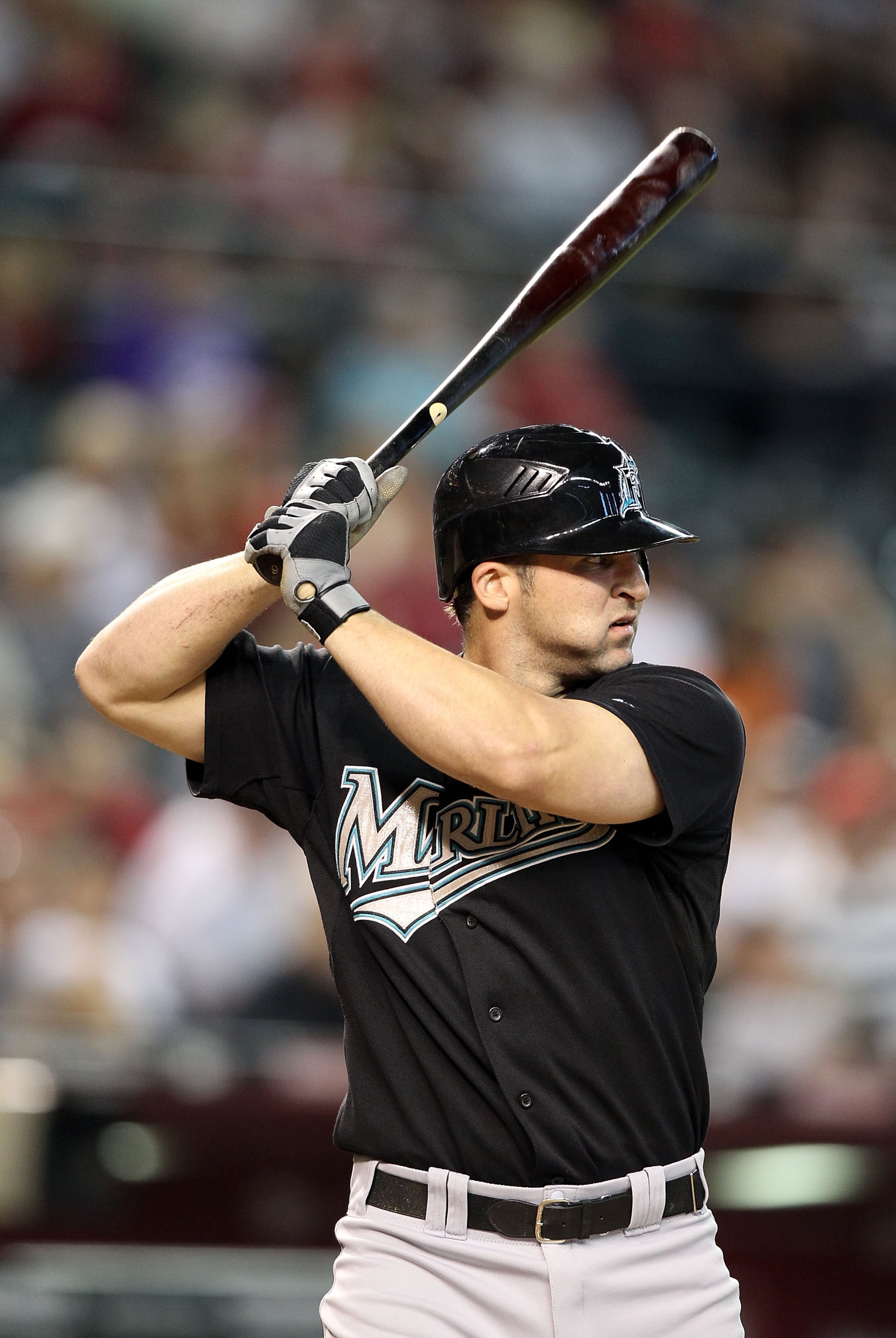 PHOENIX - JULY 11:  Cody Ross #12 of the Florida Marlins bats against the Arizona Diamondbacks during the Major League Baseball game at Chase Field on July 11, 2010 in Phoenix, Arizona.  The Marlins defeated the Diamondbacks 2-0.  (Photo by Christian Pete
