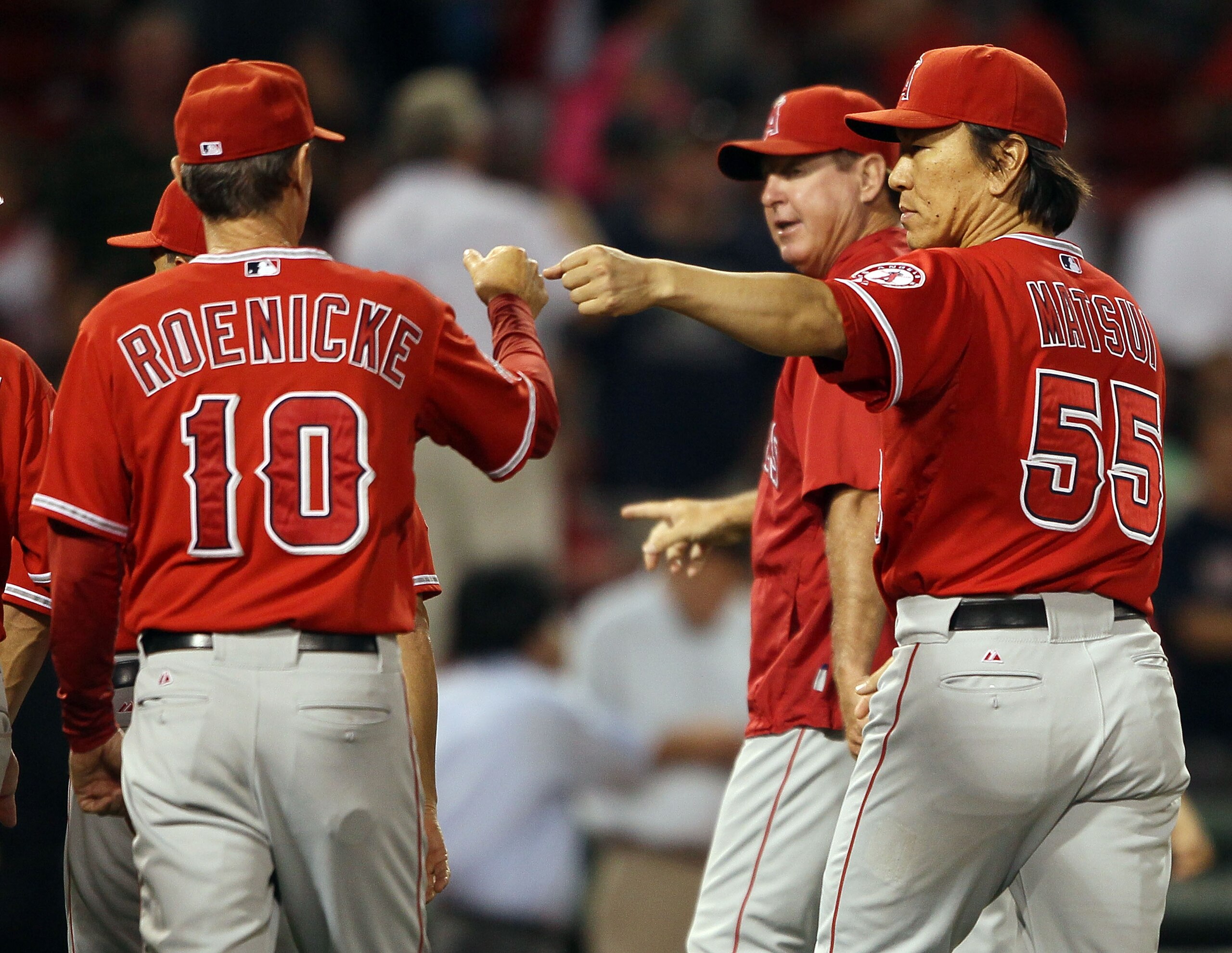 BOSTON - AUGUST 19:  Hideki Matsui #55 of the Los Angeles Angels of Anaheim celebrates the win with Ron Roenicke #10 on August 19, 2010 at Fenway Park in Boston, Massachusetts. The Angels defeated the Boston Red Sox 7-2.  (Photo by Elsa/Getty Images)