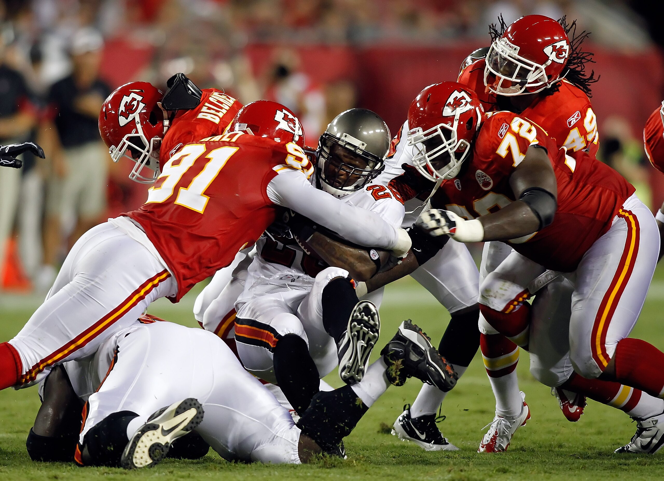 TAMPA, FL - AUGUST 21: Defenders Tamba Hali #91 and Glenn Dorsey #72 of the Kansas City Chiefs tackle running back Derrick Ward #28 of the Tampa Bay Buccaneers during a preseason game at Raymond James Stadium on August 21, 2010 in Tampa, Florida. (Photo TAMPA, FL - AUGUST 21: Defenders Tamba Hali #91 and Glenn Dorsey #72 of the Kansas City Chiefs tackle running back Derrick Ward #28 of the Tampa Bay Buccaneers during a preseason game at Raymond James Stadium on August 21, 2010 in Tampa, Florida. (Photo