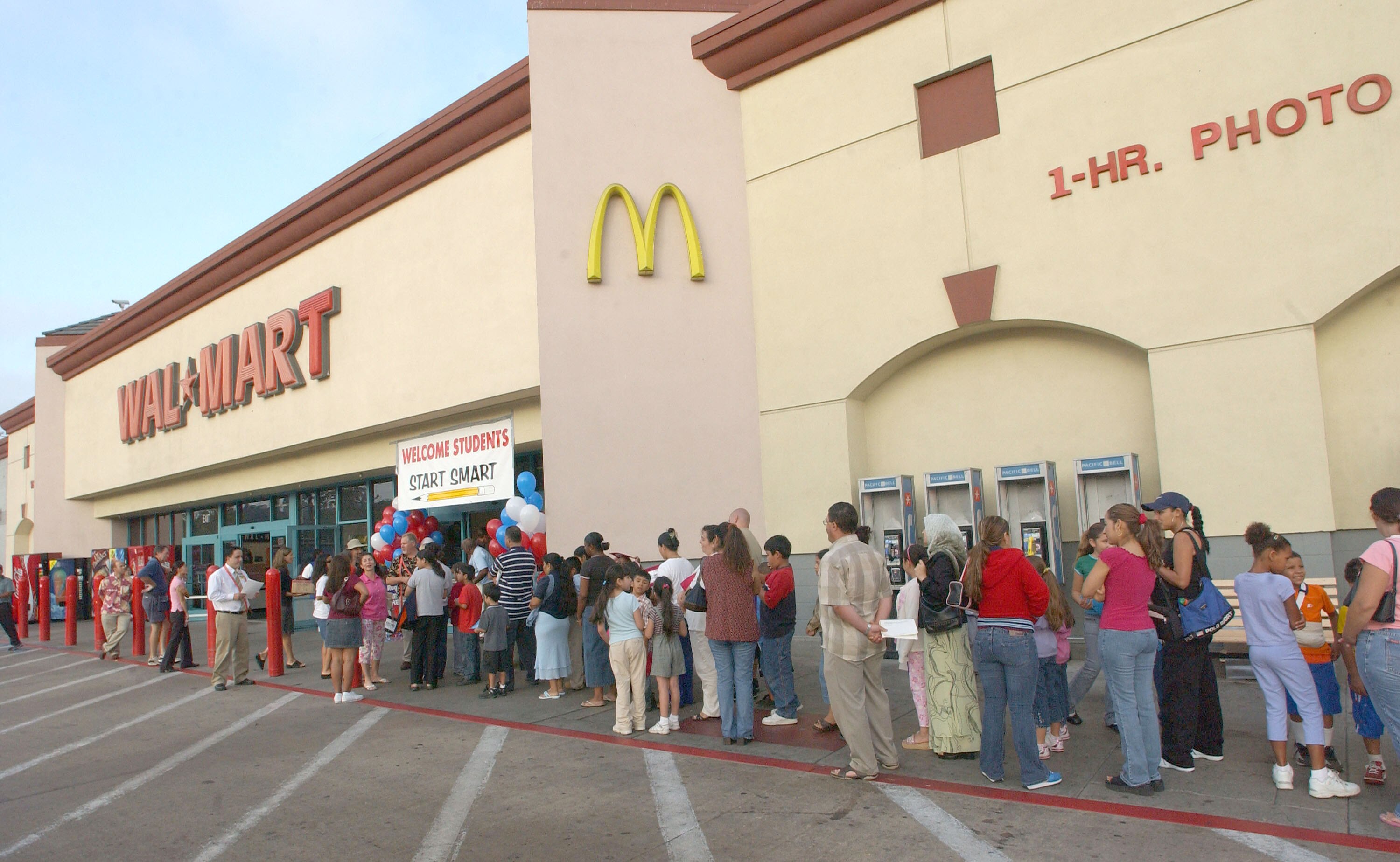 UNITED STATES - JULY 30:  Children and parents wait outside the San Diego Murphy Canyon Wal-Mart store as they participate in a $225,000 shopping spree on July 30, 2005. Approximately 1,000 needy San Diego County children participated in the back-to-schoo