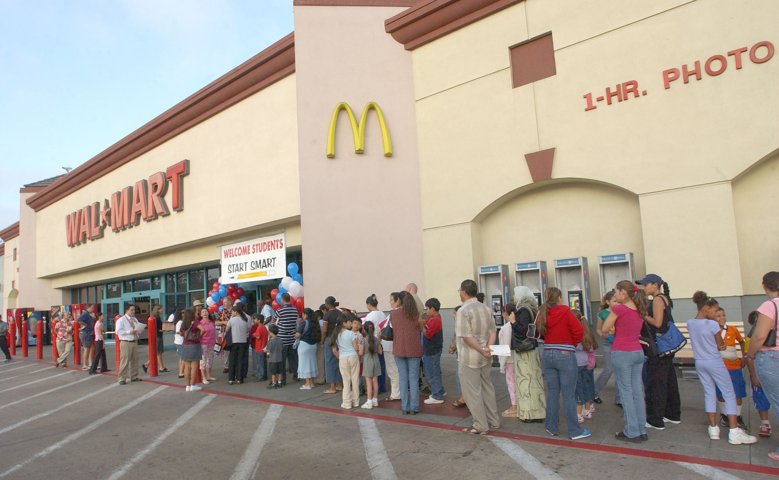 UNITED STATES - JULY 30:  Children and parents wait outside the San Diego Murphy Canyon Wal-Mart store as they participate in a $225,000 shopping spree on July 30, 2005. Approximately 1,000 needy San Diego County children participated in the back-to-schoo