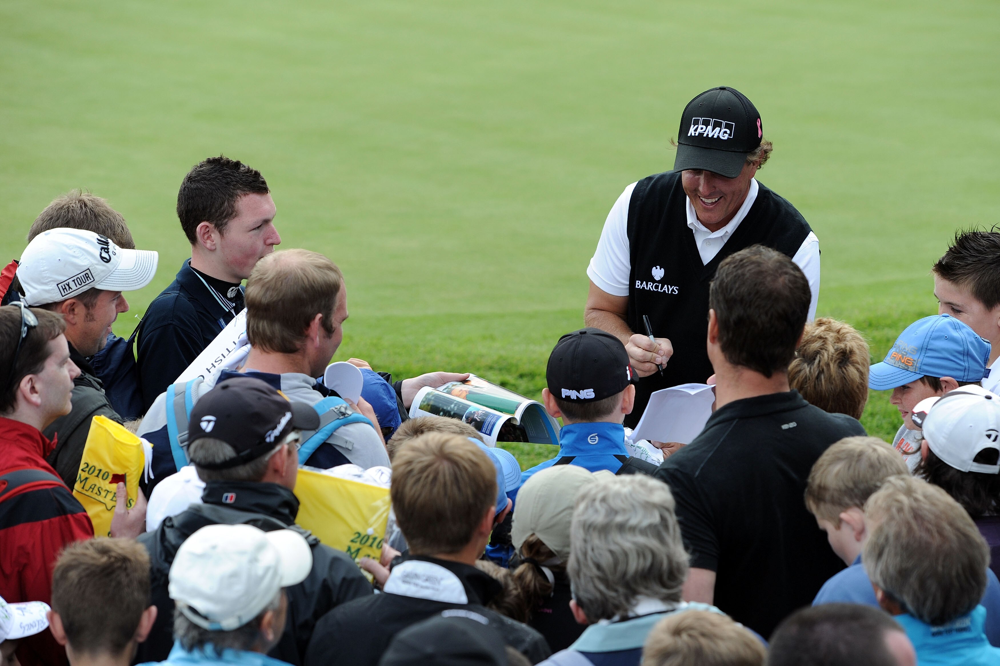 GLASGOW, SCOTLAND - JULY 07:  Phil Mickelson of the United States signs autographs for fans during a Pro-Am prior to The Barclays Scottish Open at Loch Lomond on July 7, 2010 in Glasgow, Scotland.  (Photo by Harry How/Getty Images)