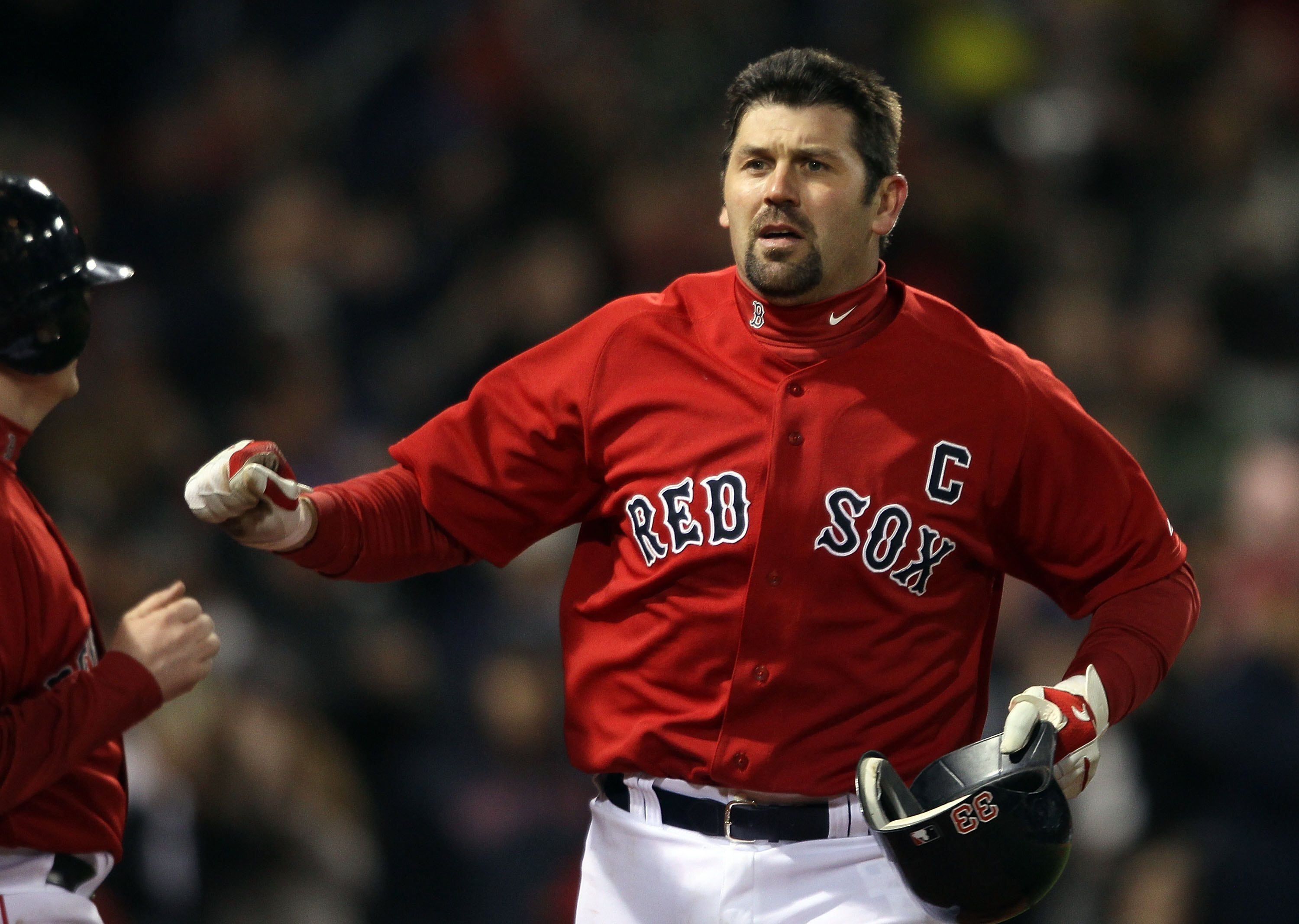 BOSTON - APRIL 16:  Jason Varitek #33 of the Boston Red Sox celebrates his solo home run in the fifth inning against the Tampa Bay Rays on April 16, 2010 at Fenway Park in Boston, Massachusetts.  (Photo by Elsa/Getty Images)