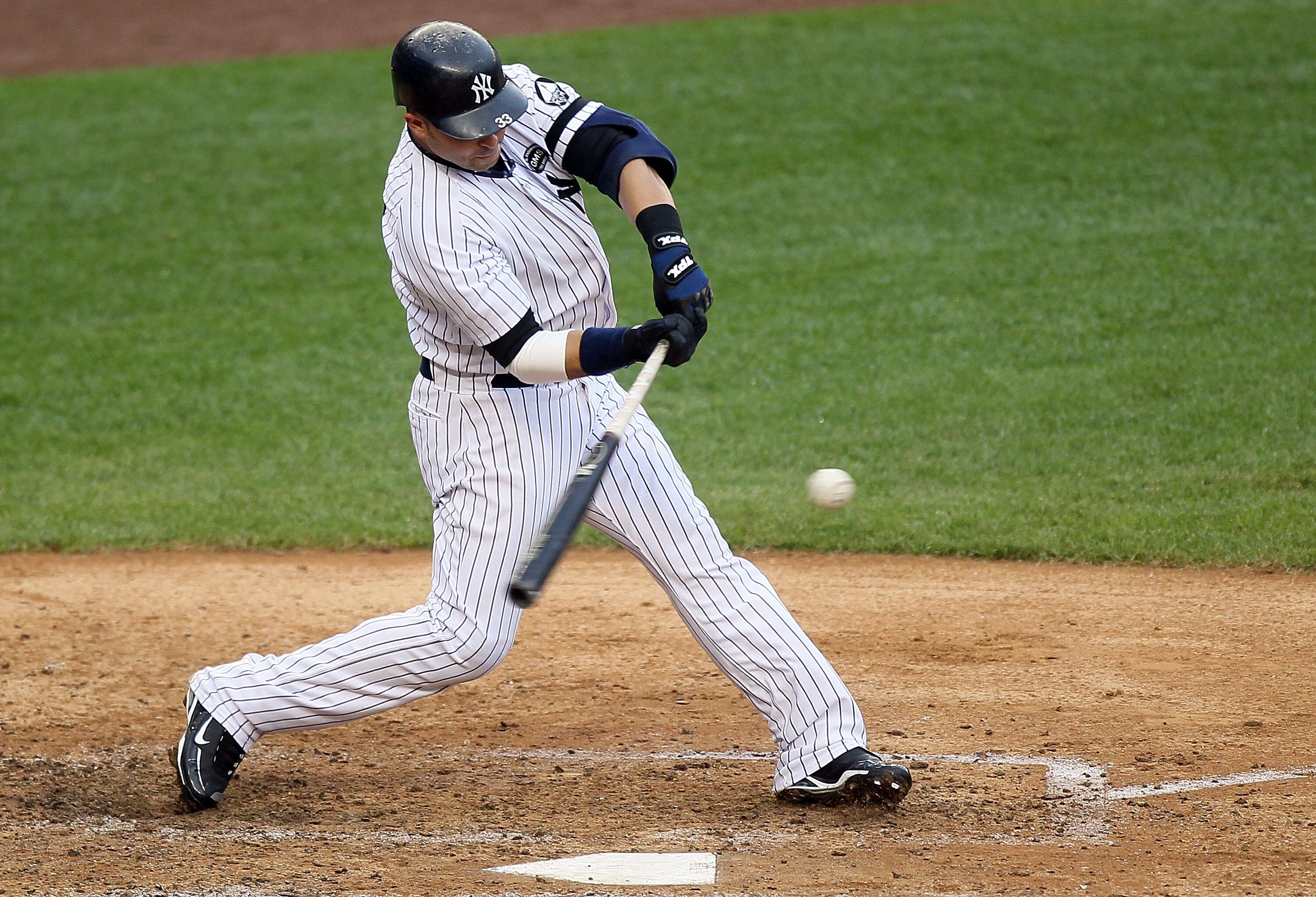 NEW YORK - AUGUST 22:  Nick Swisher #33 of the New York Yankees connects on a fifth inning single against the Seattle Mariners on August 22, 2010 at Yankee Stadium in the Bronx borough of New York City.  (Photo by Jim McIsaac/Getty Images)
