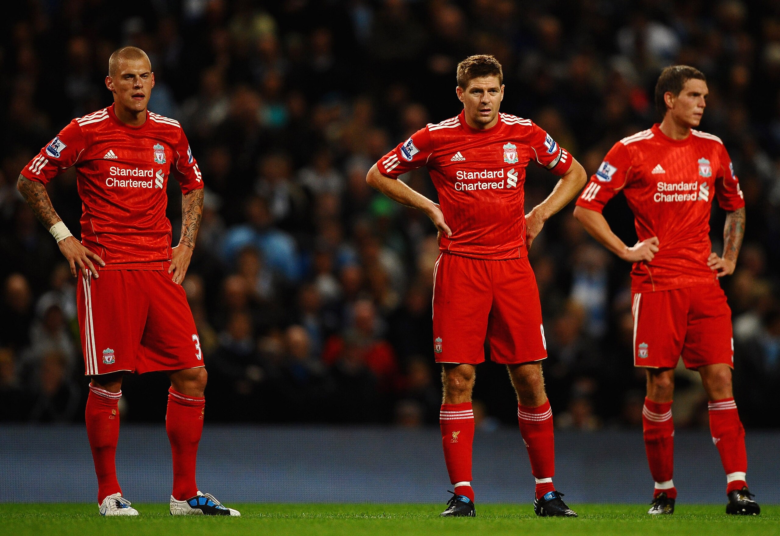 MANCHESTER, ENGLAND - AUGUST 23: Steven Gerrard of Liverpool shows his disappointment alonside Daniel Agger and Martin Skirtl during the Barclays Premier League match between Manchester City and Liverpool at City of Manchester Stadium on August 23, 2010 i