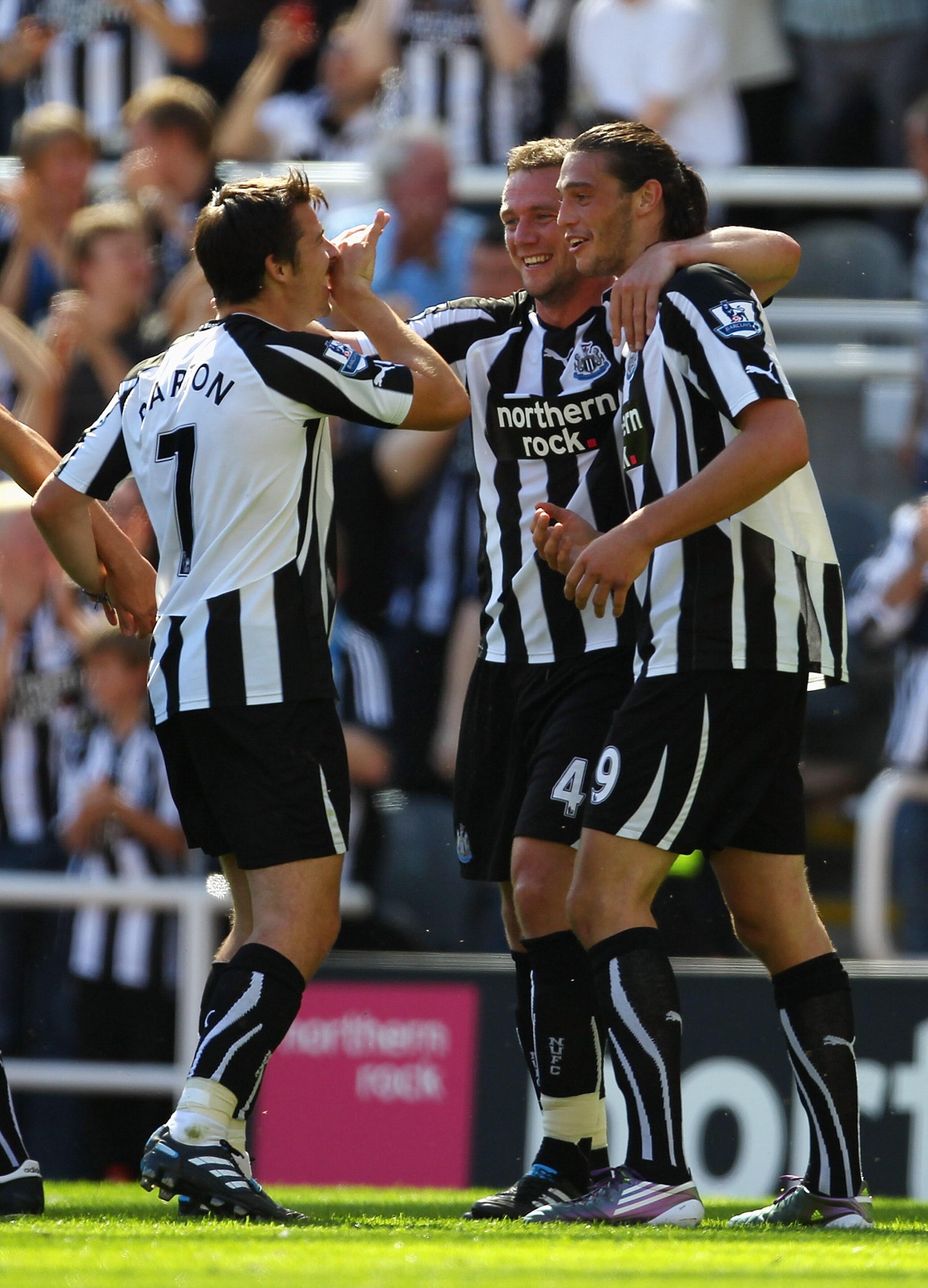 NEWCASTLE UPON TYNE, ENGLAND - AUGUST 22:  Andy Carroll of Newcastle United celebrates with Joey Barton and Kevin Nolan after scoring his first goal during the Barclays Premier League match between Newcastle United and Aston Villa at St James' Park on Aug