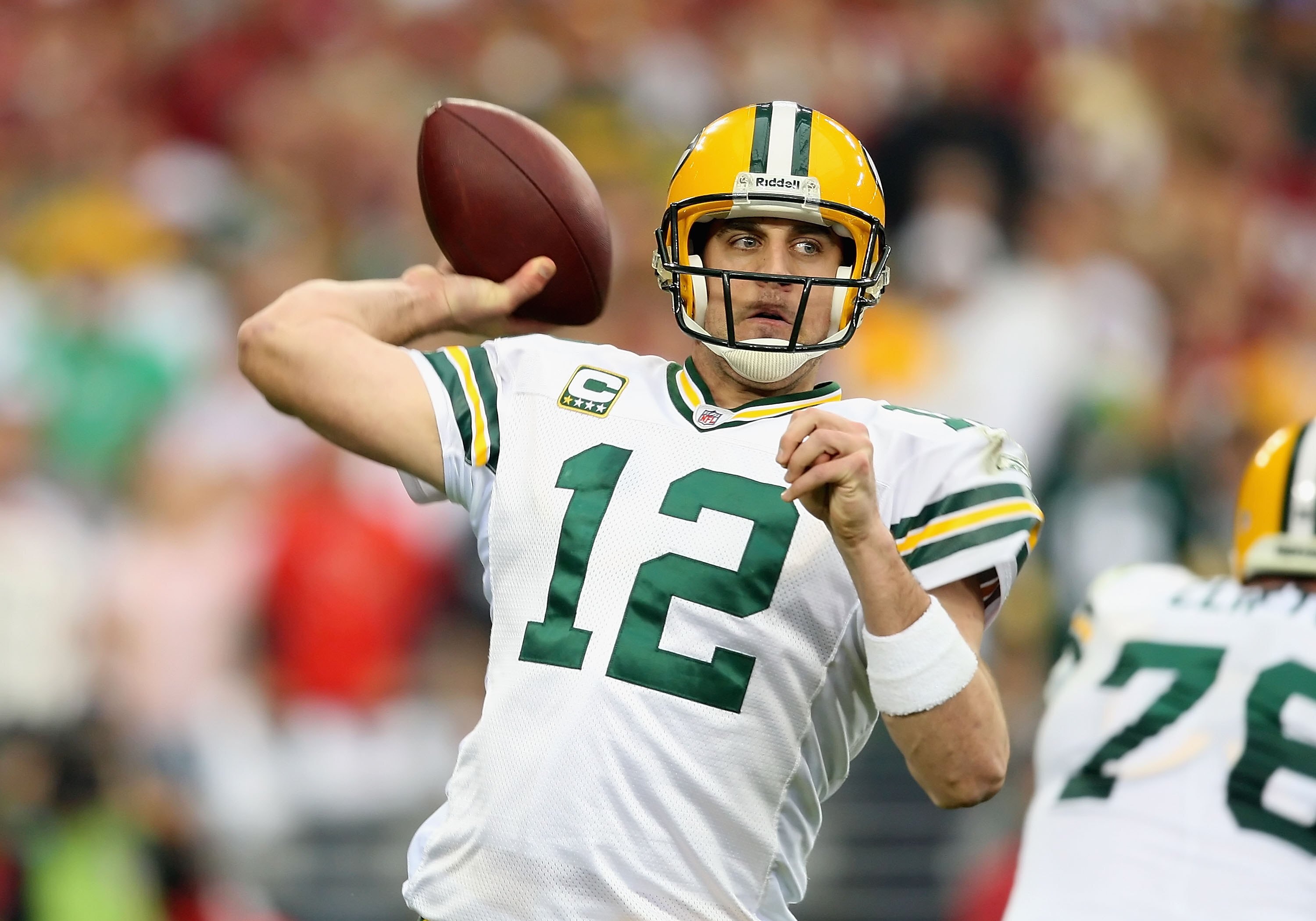 GLENDALE, AZ - JANUARY 10:  Quarterback Aaron Rodgers #12 of the Green Bay Packers throws a pass during the 2010 NFC wild-card playoff game against  the Arizona Cardinals at the Universtity of Phoenix Stadium on January 10, 2010 in Glendale, Arizona.  The