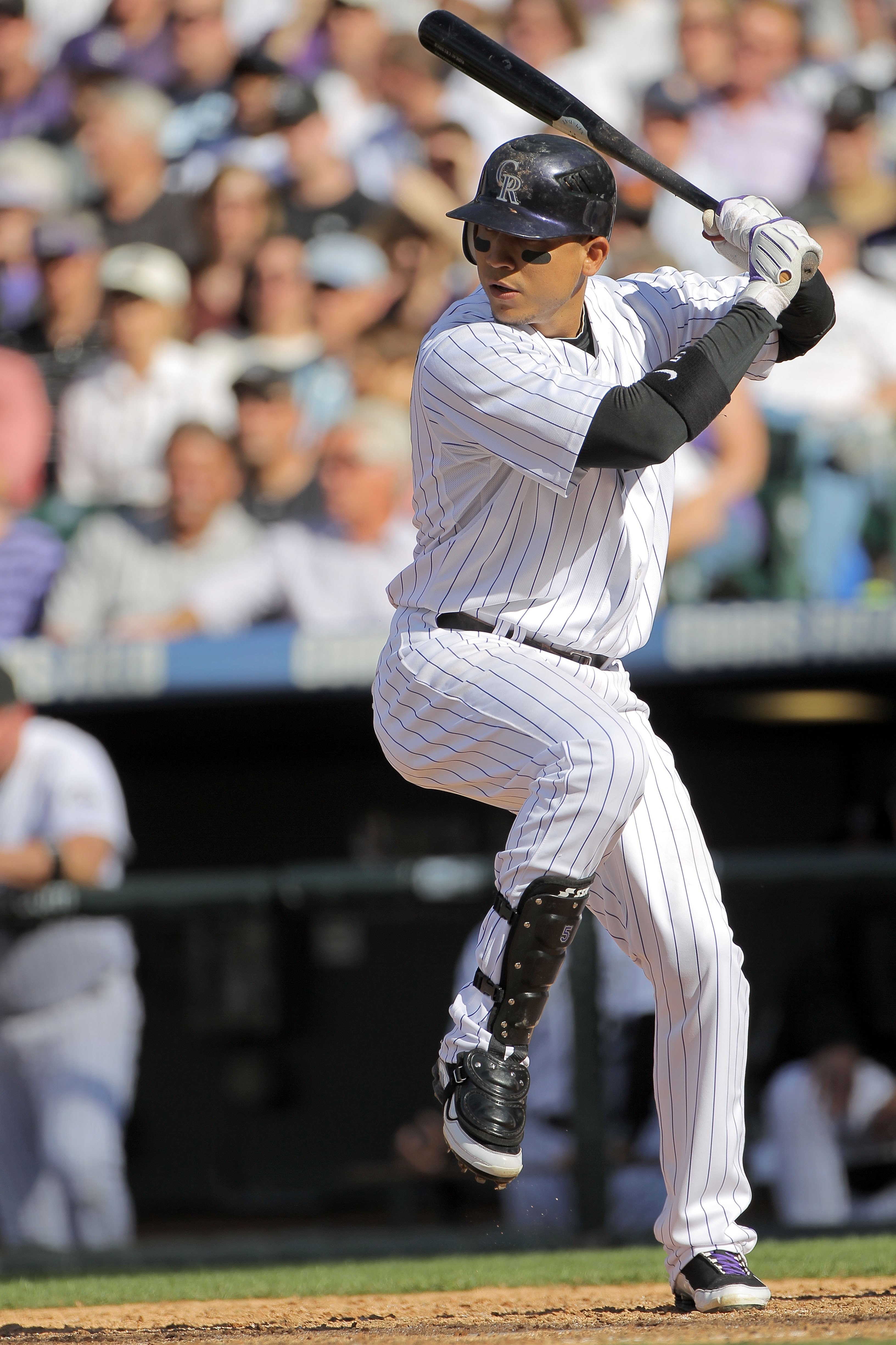 DENVER - APRIL 09:  Carlos Gonzalez #5 of the Colorado Rockies takes an at bat against the San Diego Padres during MLB action on Opening Day at Coors Field on April 9, 2010 in Denver, Colorado. The Rockies defeated the Padres 7-0.  (Photo by Doug Pensinge