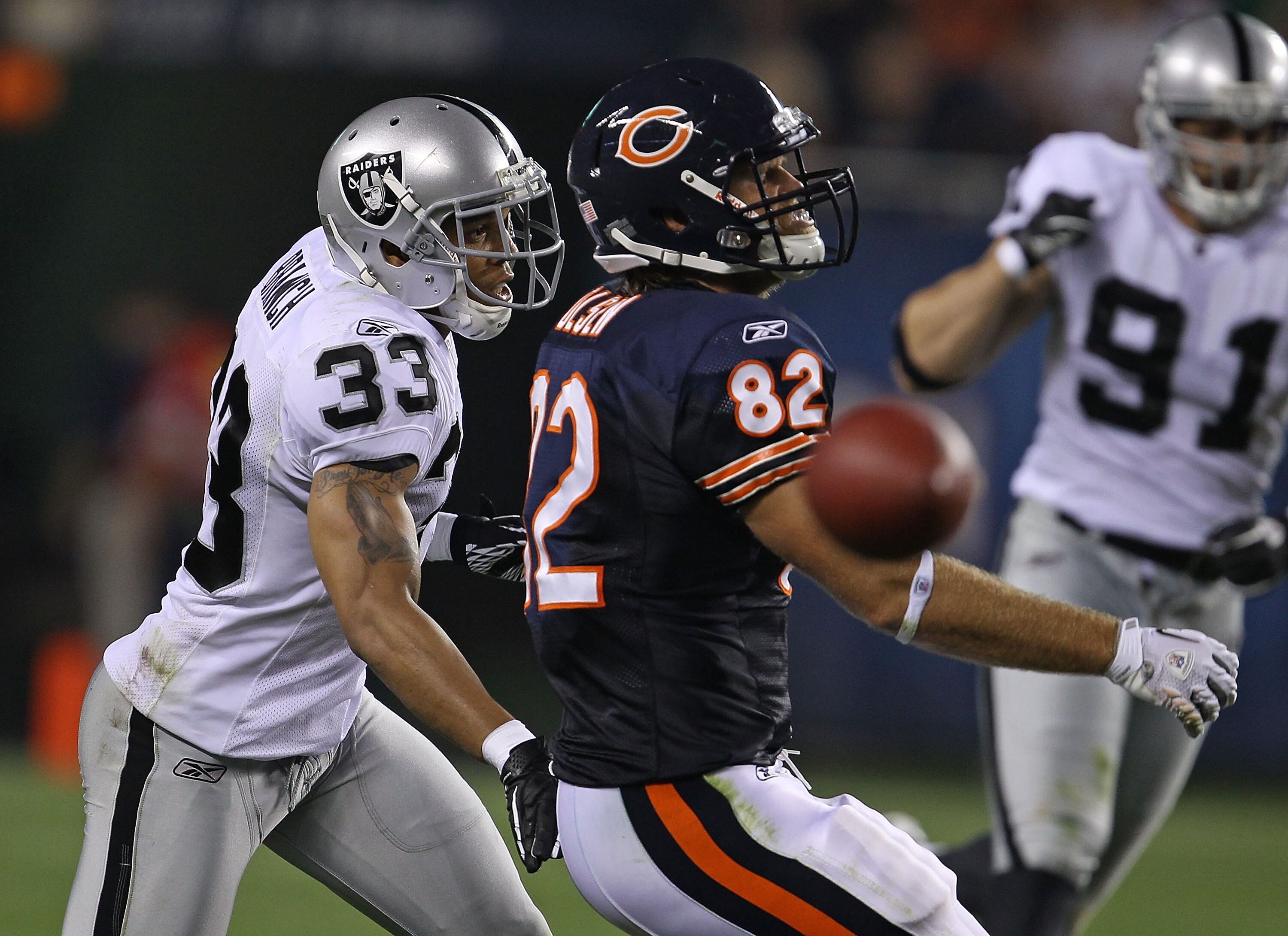 CHICAGO - AUGUST 21: Tyvon Branch #33 of the Oakland Raiders breaks up a pass intended for Greg Olsen #82 of the Chicago Bears during a preseason game at Soldier Field on August 21, 2010 in Chicago, Illinois. The Raiders defeated the Bears 32-17. (Photo b