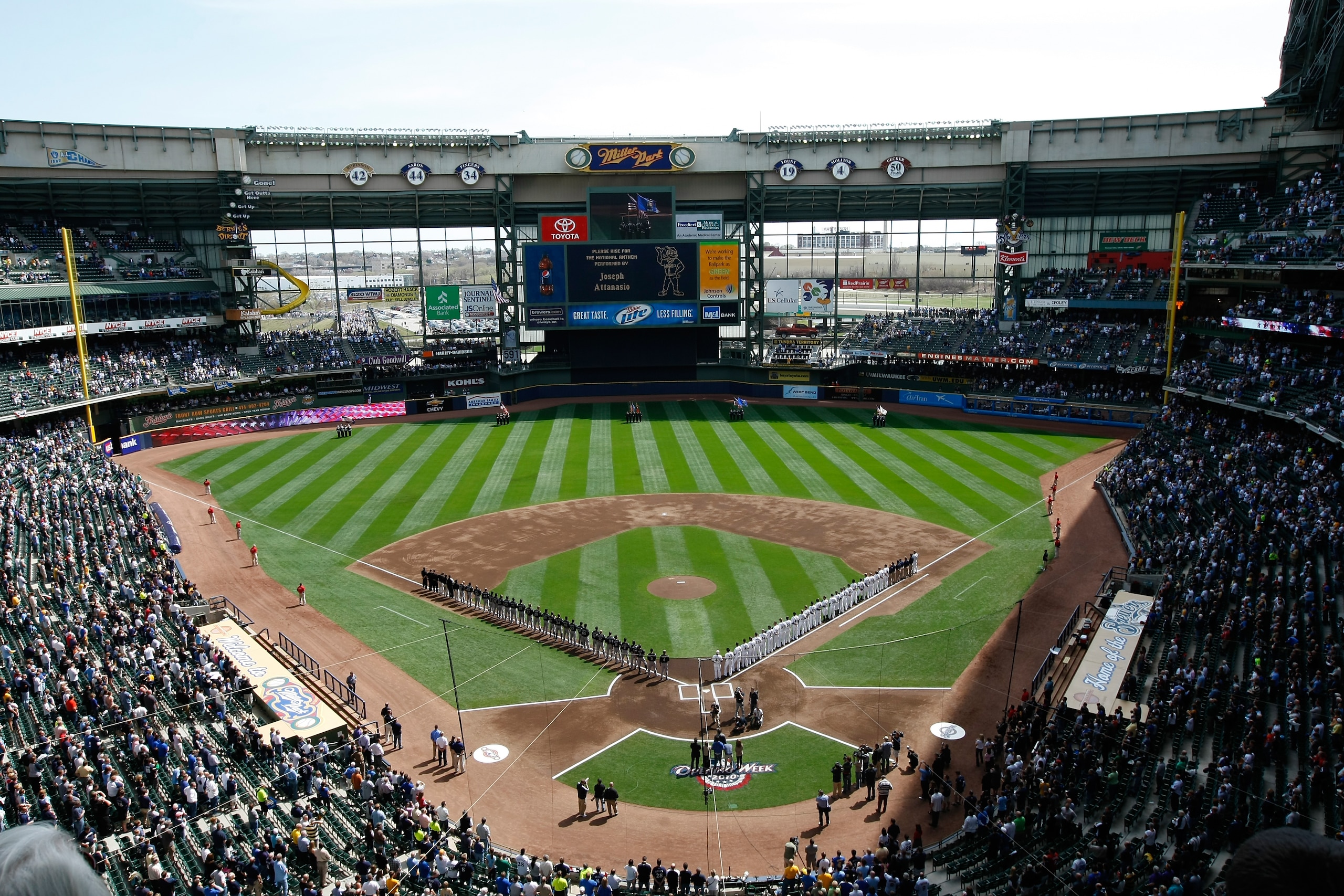 MILWAUKEE, WI - APRIL 05: The Colorado Rockies and Milwaukee Brewers line up on the base lines after introductions during the National Anthem prior to the game between the Colorado Rockies against the Milwaukee Brewers at the Miller Park on April 05, 2010