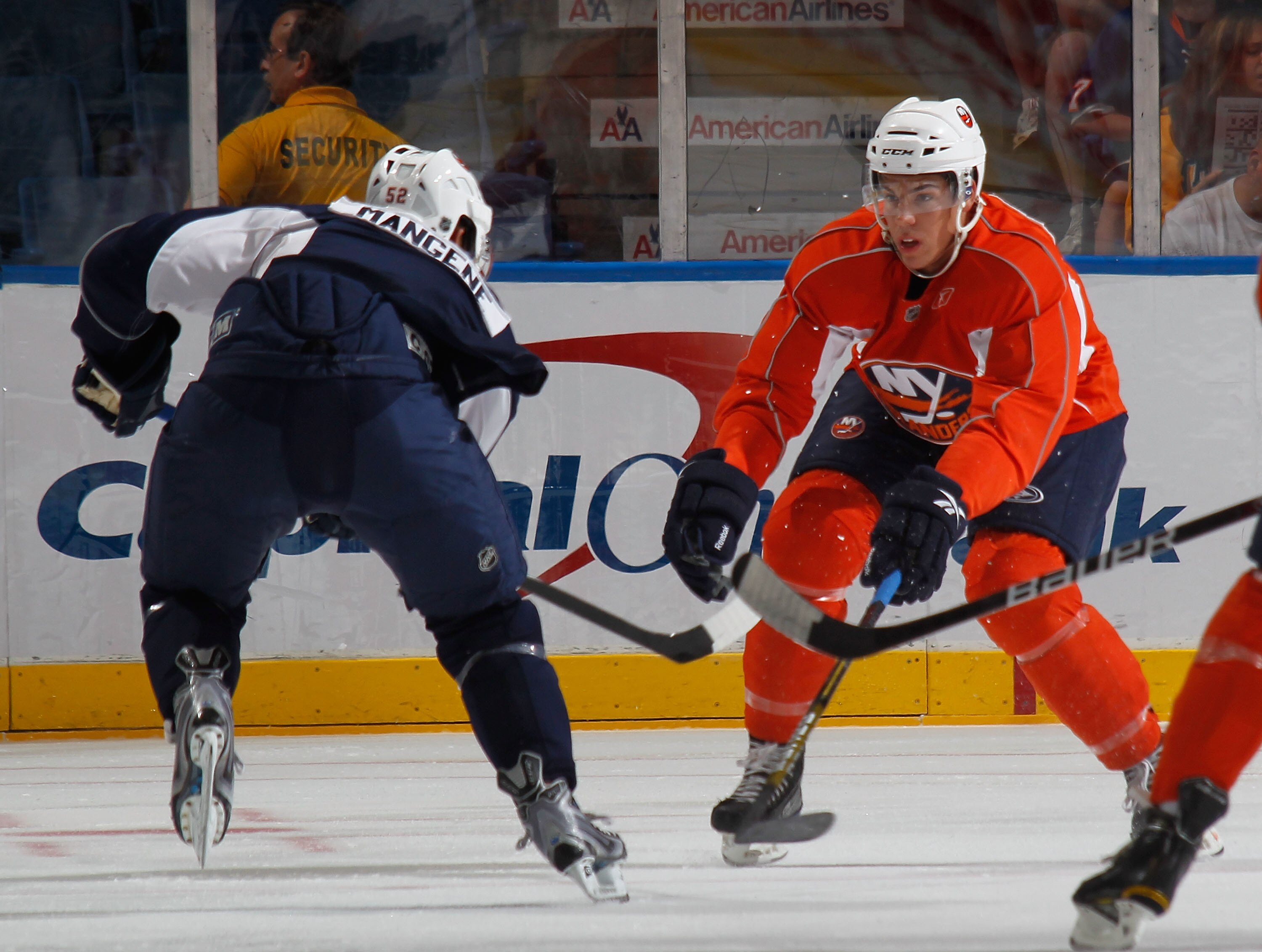 UNIONDALE, NY - JULY 10:  Islanders defenseman Travis Hamonic defends a shot by Islanders Matt Mangene during a scrimmage game at the New York Islanders Rookie camp at Nassau Veterans Memorial Coliseum on July 10, 2010 in Uniondale, New York.  (Photo by P