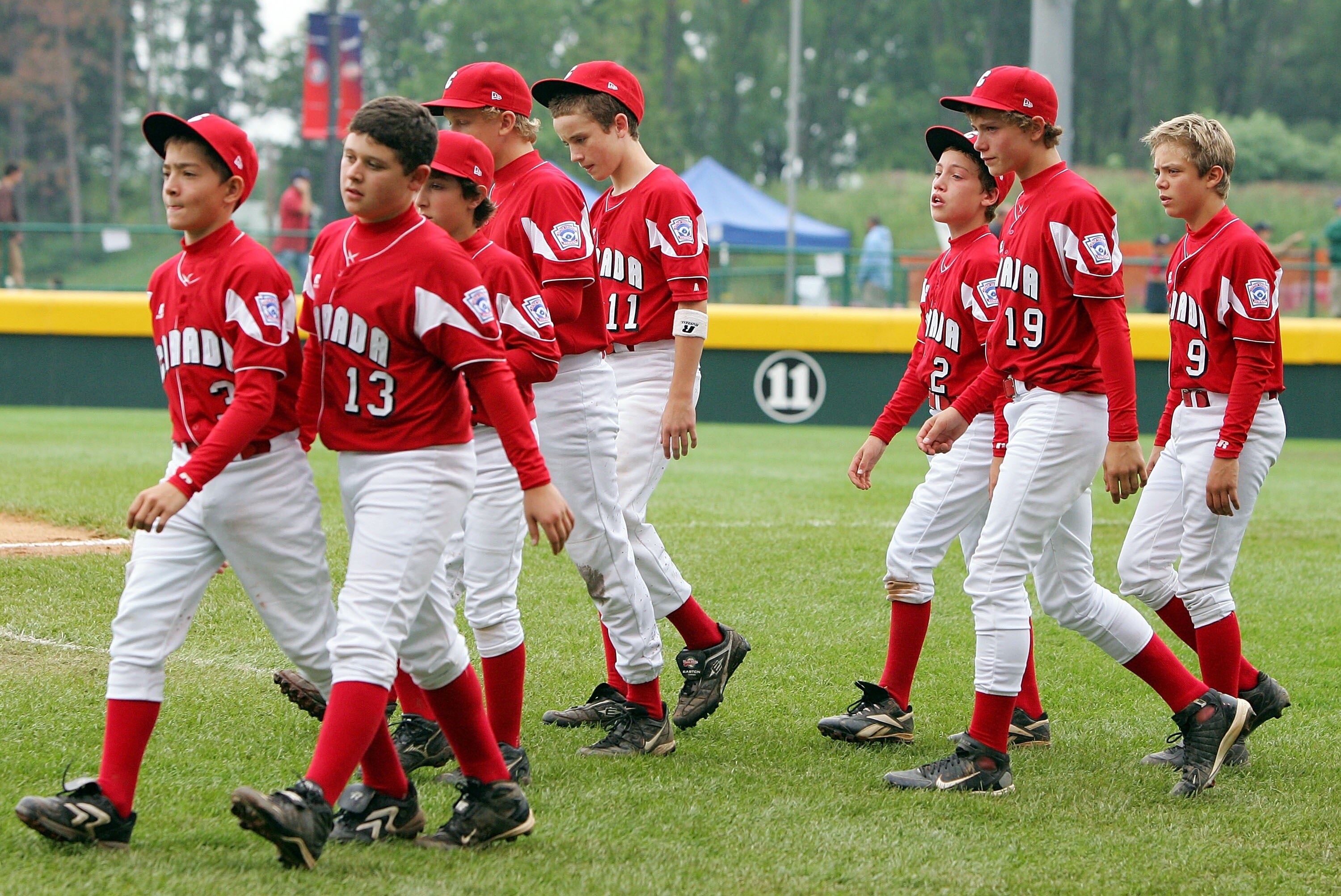SOUTH WILLIAMSPORT, PA - AUGUST 22: Members of the Canadian team from White Rock, British Columbia walk on the field after losing to the Caribbean team from Willemstad, Curacao during their tournament game in the Little League World Series on August 22, 2