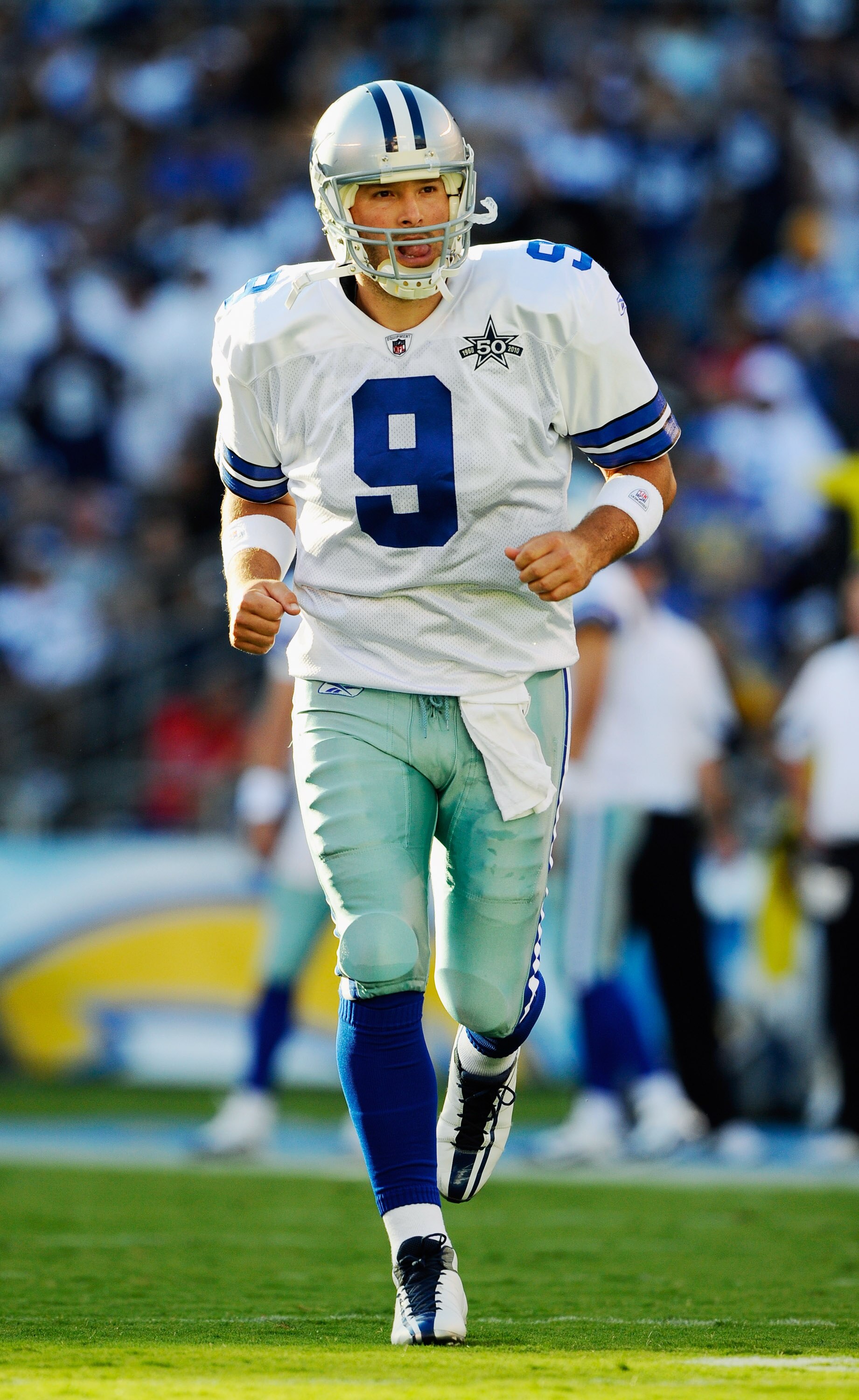 SAN DIEGO - AUGUST 21:  Quarterback Tony Romo #9 of the Dallas Cowboys jogs in for the first play of  their preseason NFL football game against San Diego Chargers at Qualcomm Stadium on August 21, 2010 in San Diego, California.  (Photo by Kevork Djansezia