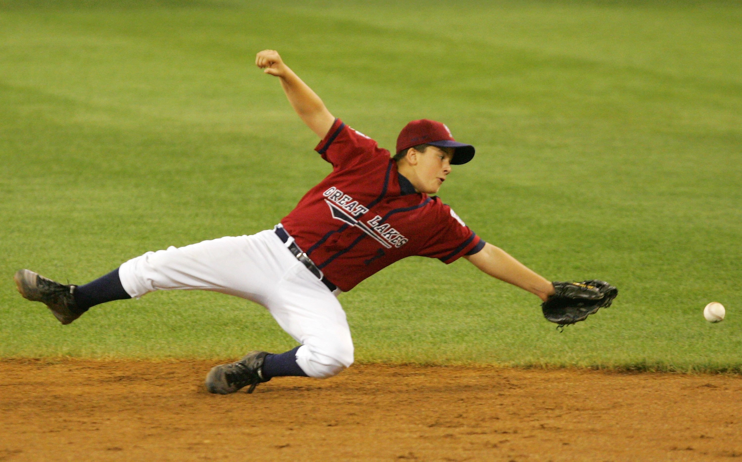 SOUTH WILLIAMSPORT, PA - AUGUST 23:  Michael Hall #7 of the Great Lakes team from Illinois can't come up with the ball on a double hit by Jace Fry of the Northwest team from Oregon during the United States Semifinal game in the Little League World Series 