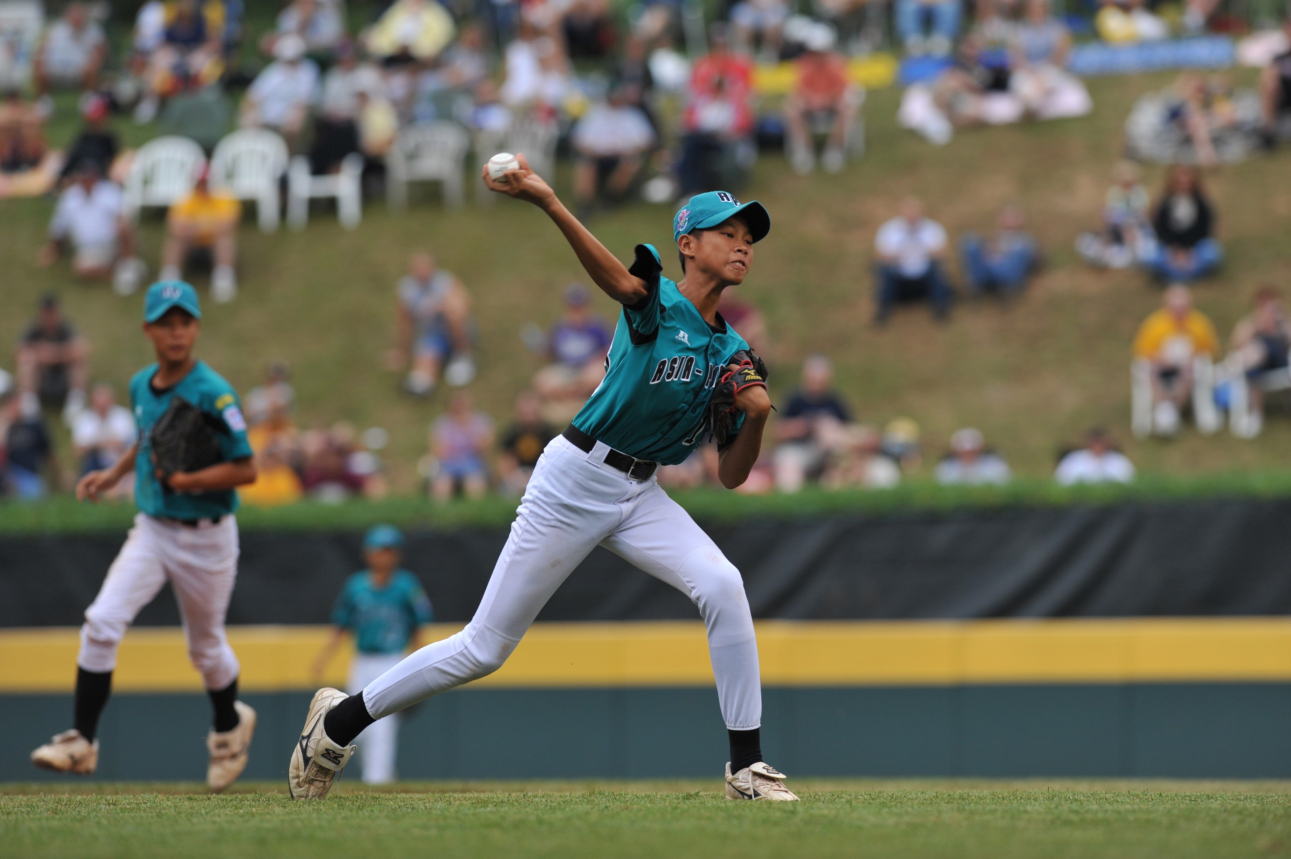 WILLIAMSPORT, PA - AUGUST 27: Third baseman Cheng Chieh Lee #13of Asia Pacific (Chinese Taipei) throws to first during a play against  the Caribbean (Curacao) in the international semifinal at Lamade Stadium on August 27, 2009 in Williamsport, Pennsylvani