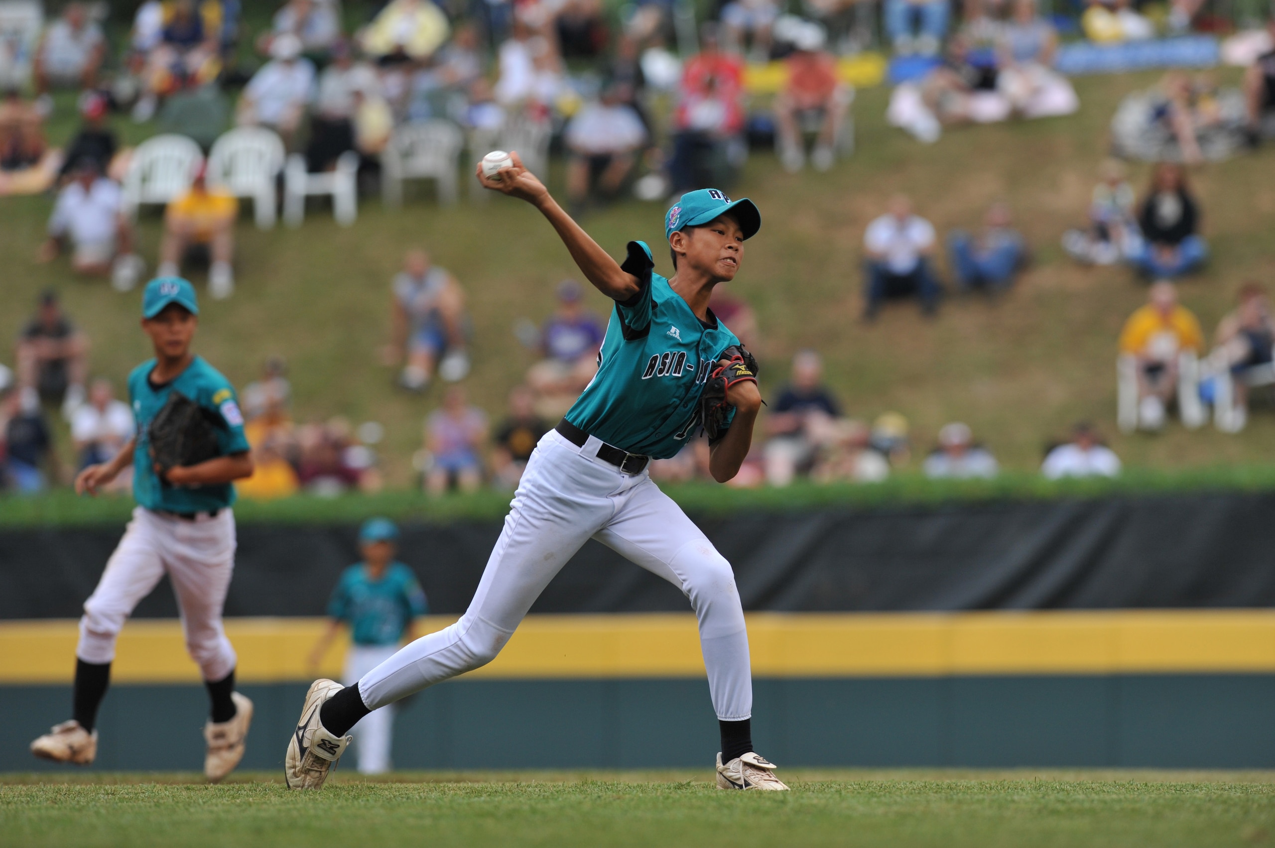 WILLIAMSPORT, PA - AUGUST 27: Third baseman Cheng Chieh Lee #13of Asia Pacific (Chinese Taipei) throws to first during a play against the Caribbean (Curacao) in the international semifinal at Lamade Stadium on August 27, 2009 in Williamsport, Pennsylvani WILLIAMSPORT, PA - AUGUST 27: Third baseman Cheng Chieh Lee #13of Asia Pacific (Chinese Taipei) throws to first during a play against the Caribbean (Curacao) in the international semifinal at Lamade Stadium on August 27, 2009 in Williamsport, Pennsylvani