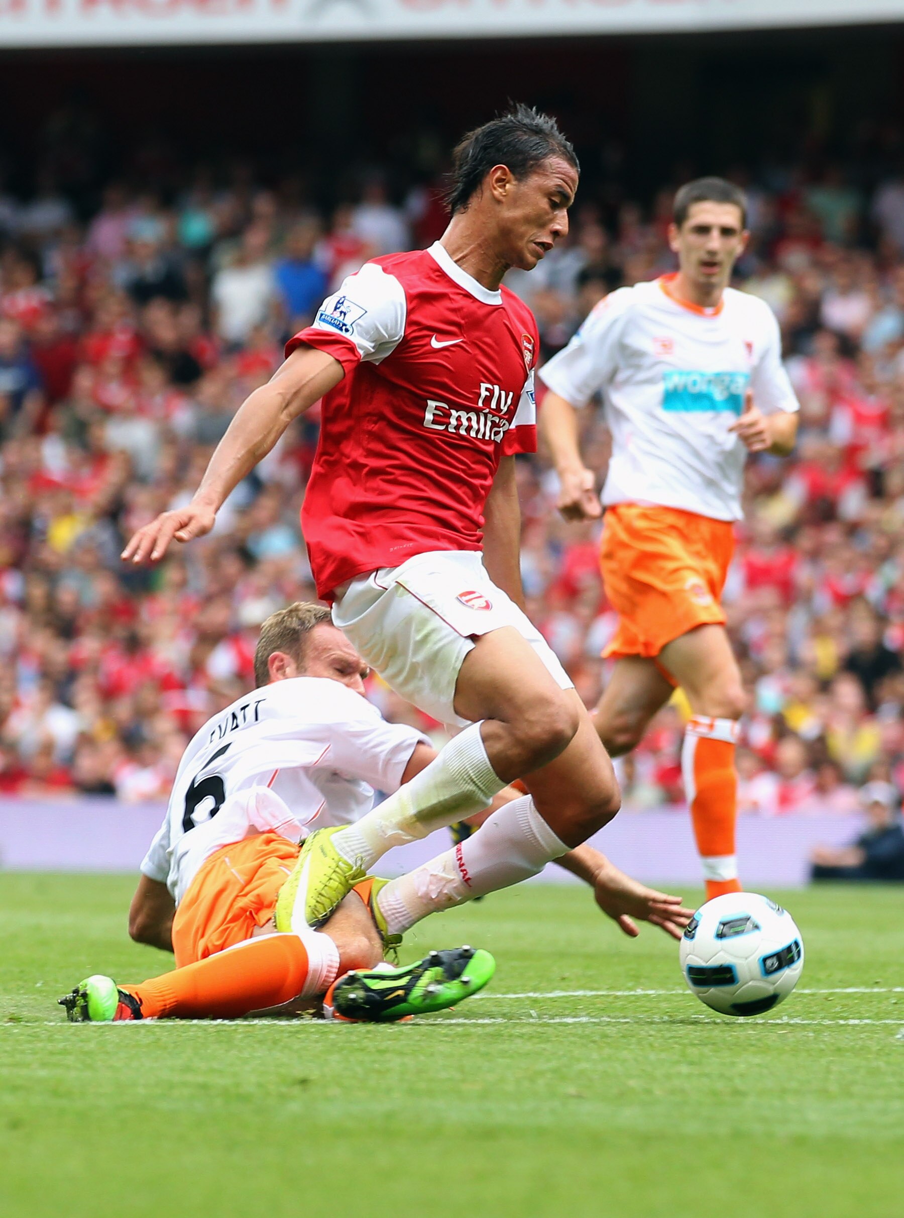 LONDON, ENGLAND - AUGUST 21:  Ian Evatt of Blackpool brings down Marouane Chamakh of Arsenal for a penalty during the Barclays Premier League match between Arsenal and Blackpool at The Emirates Stadium on August 21, 2010 in London, England.  (Photo by Cli