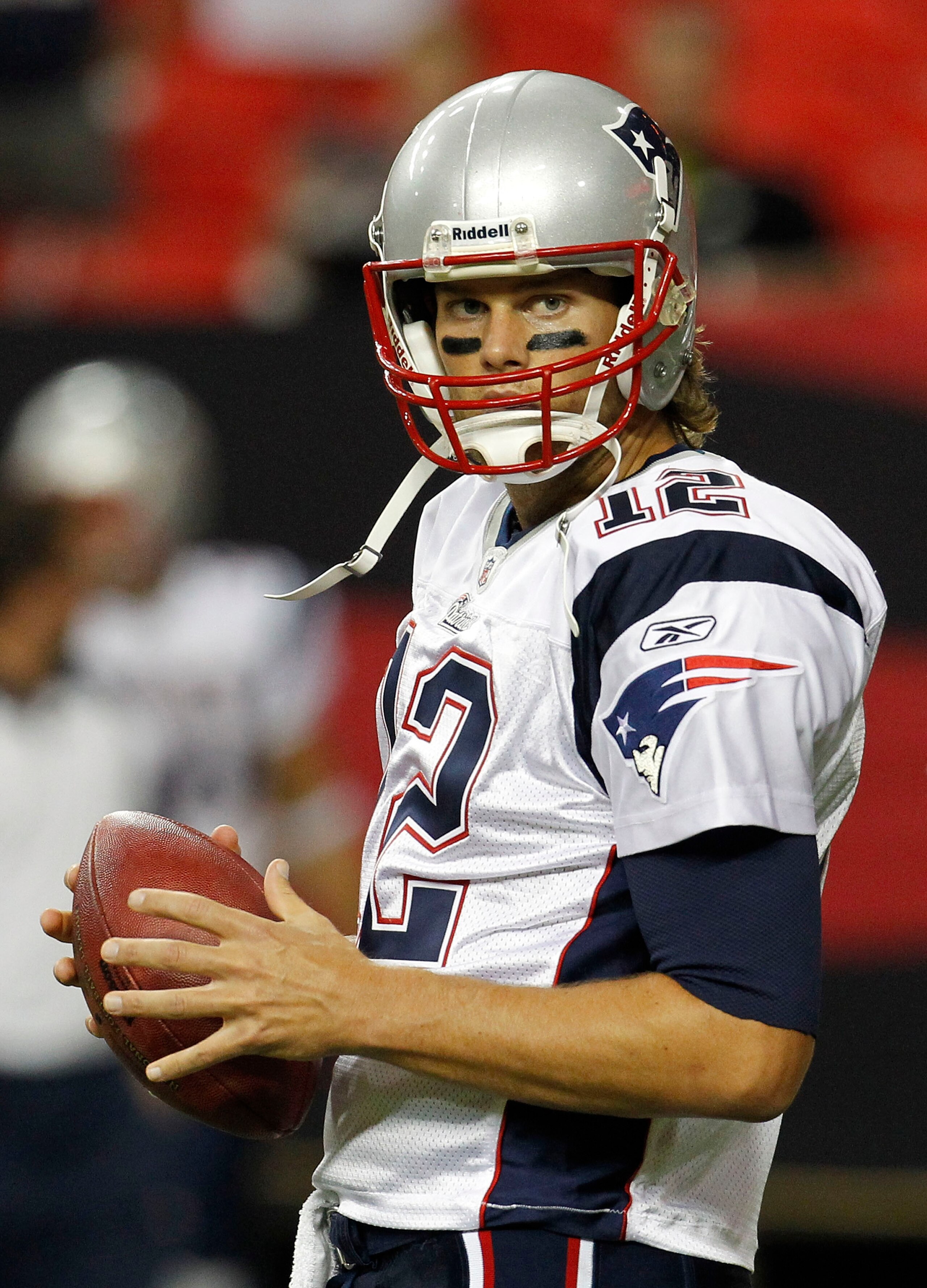 ATLANTA - AUGUST 19:  Quarterback Tom Brady #12 of the New England Patriots takes a break during pre-game drills before the preseason game against the Atlanta Falcons at the Georgia Dome on August 19, 2010 in Atlanta, Georgia.  (Photo by Mike Zarrilli/Get