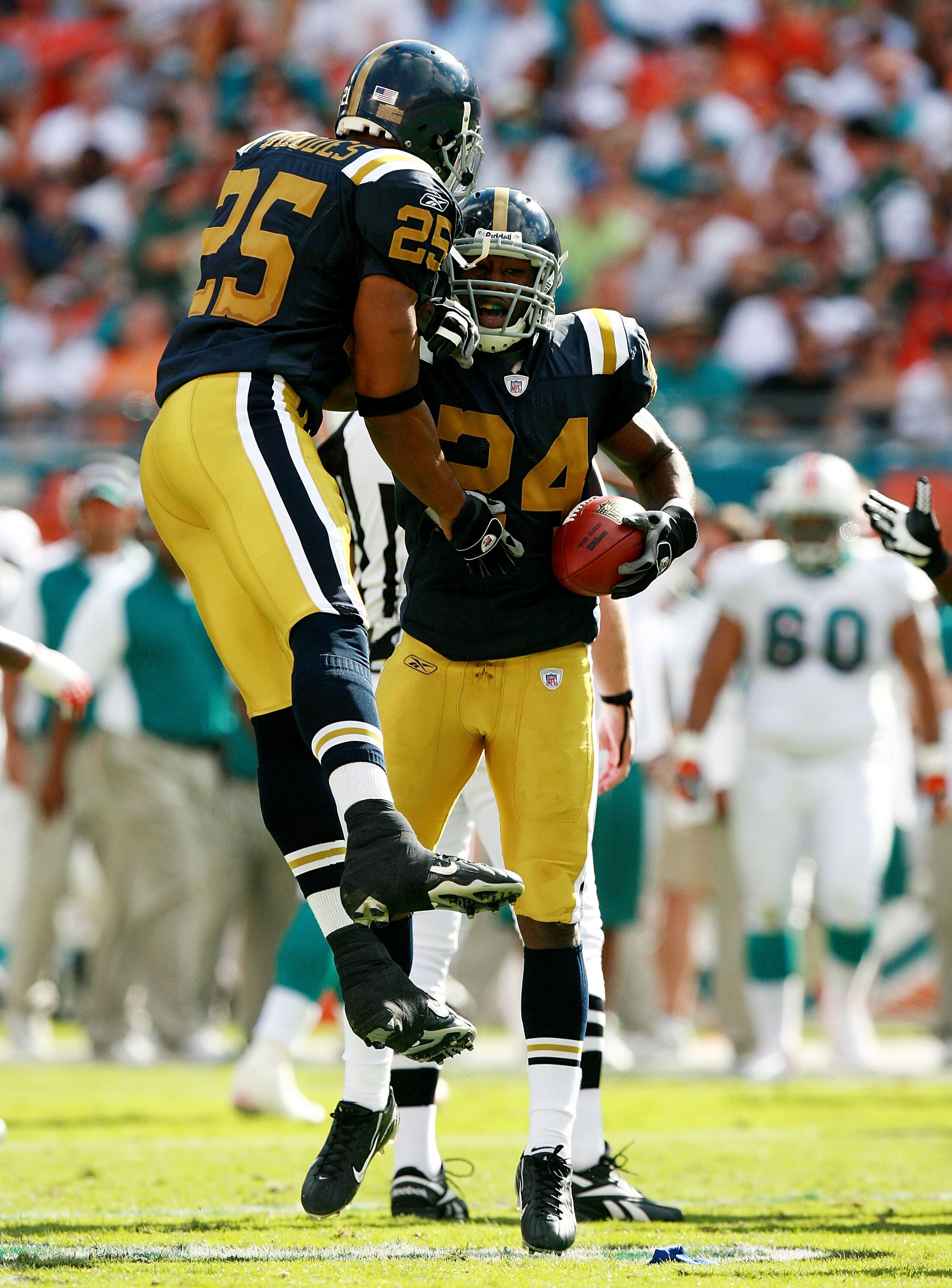 MIAMI - DECEMBER 02:  Defensive back Darrelle Revis #24 is congratulated by teammate Kerry Rhodes #25 after Revis intercepted a pass in the second quarter against the Miami Dolphins at Dolphin Stadium on December 2, 2007 in Miami, Florida. The Jets defeat