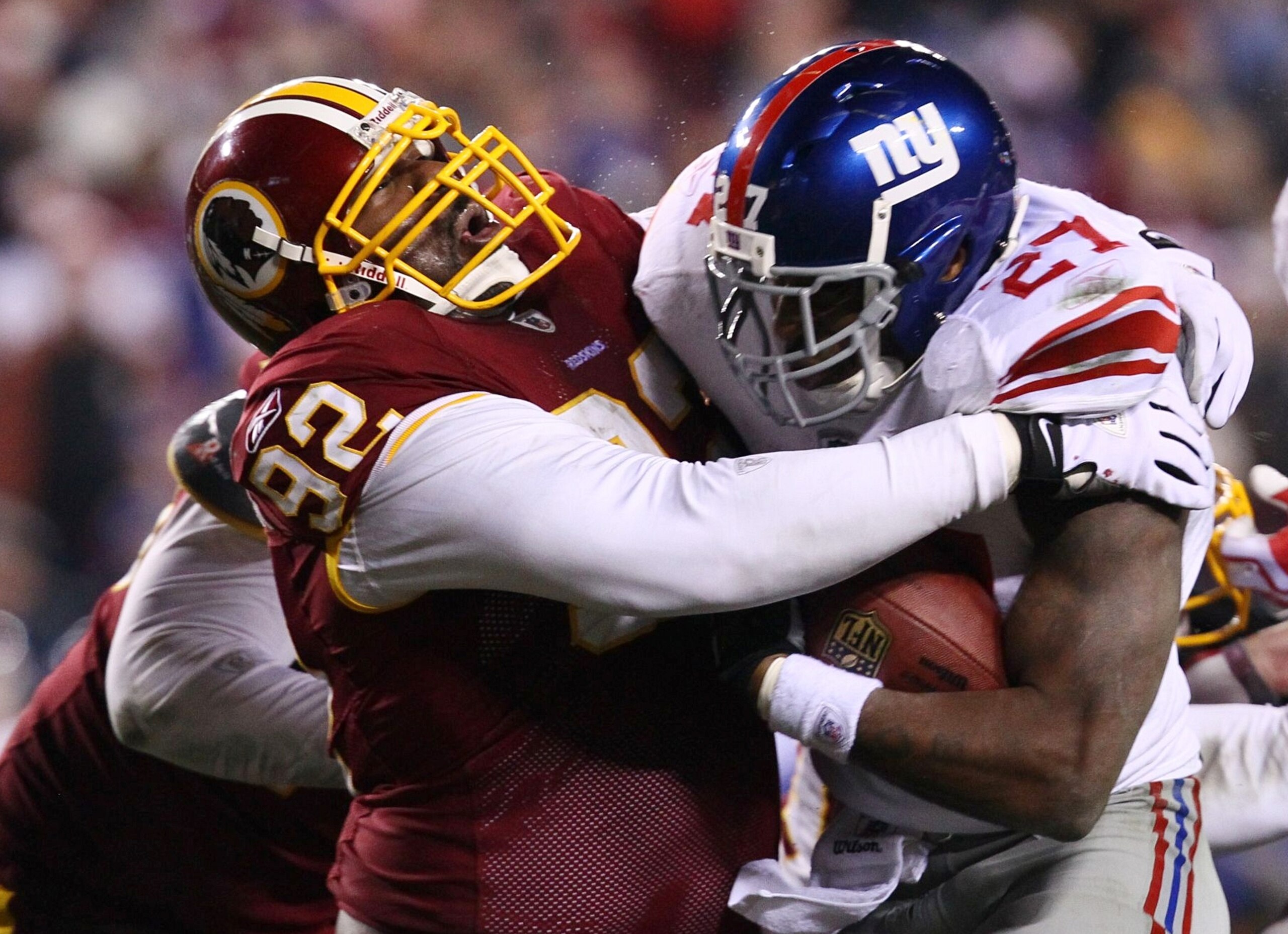 LANDOVER, MD - DECEMBER 21:  Running back Brandon Jacobs #27 of the New York Giants runs with the ball as Albert Haynesworth #92 of the Washington Redskins attempts to tackle him at FedEx Field on December 21, 2009 in Landover, Maryland. (Photo by Win McN