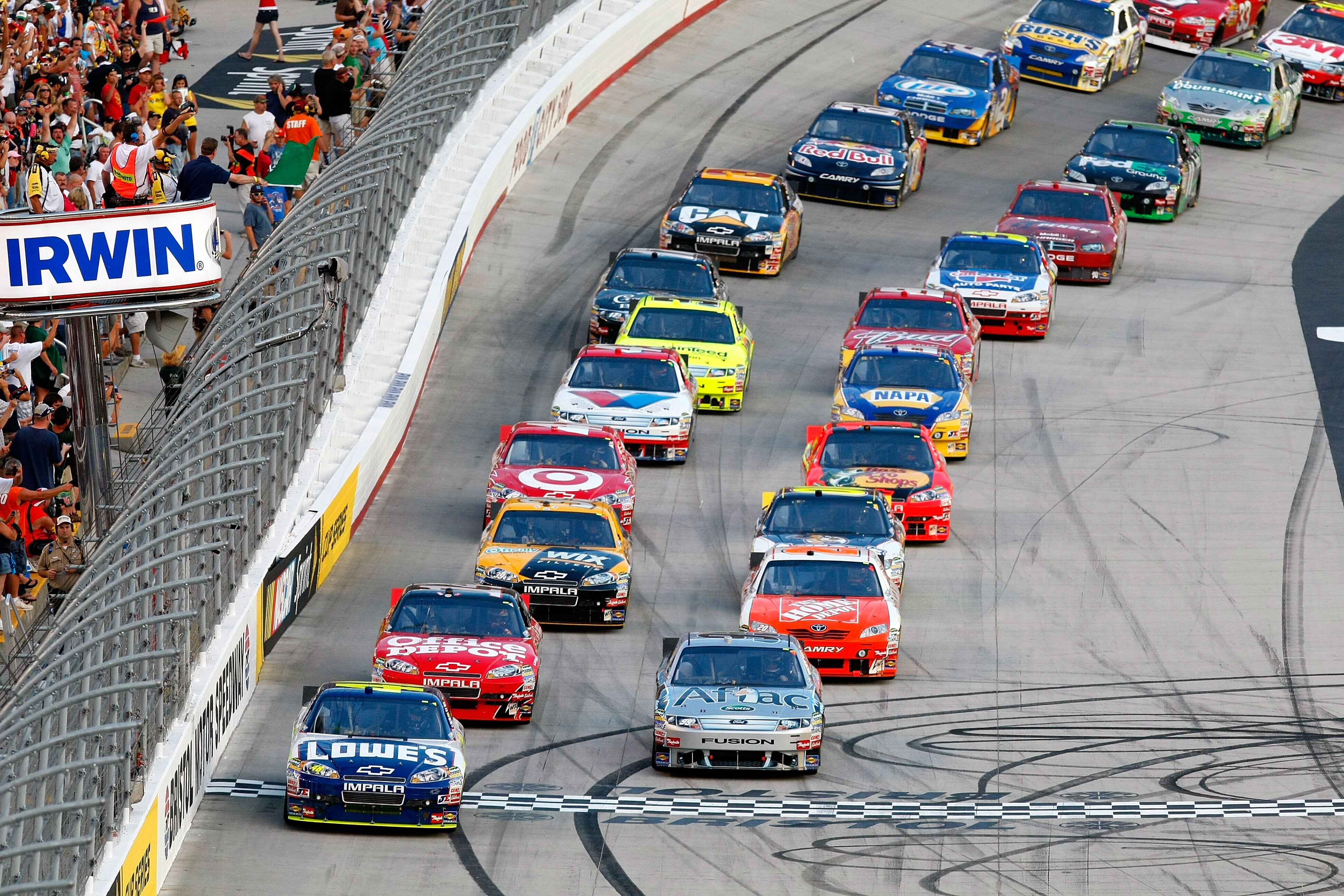 BRISTOL, TN - AUGUST 21:  Jimmie Johnson, driver of the #48 Lowe's Chevrolet, and Carl Edwards, driver of the #99 Aflac Ford, take the green flag to start the NASCAR Sprint Cup Series IRWIN Tools Night Race at Bristol Motor Speedway on August 21, 2010 in