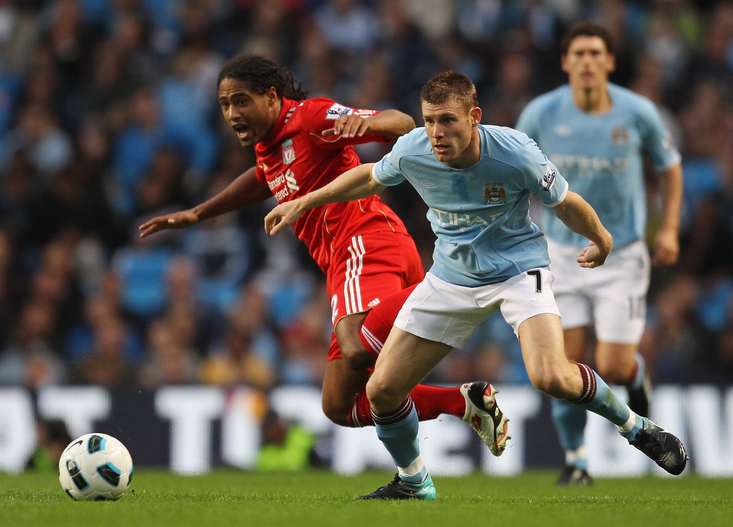 MANCHESTER, ENGLAND - AUGUST 23: James Milner of Manchester City holds off a challenge from Glen Johnson of Liverpool during the Barclays Premier League match between Manchester City and Liverpool at City of Manchester Stadium on August 23, 2010 in Manche