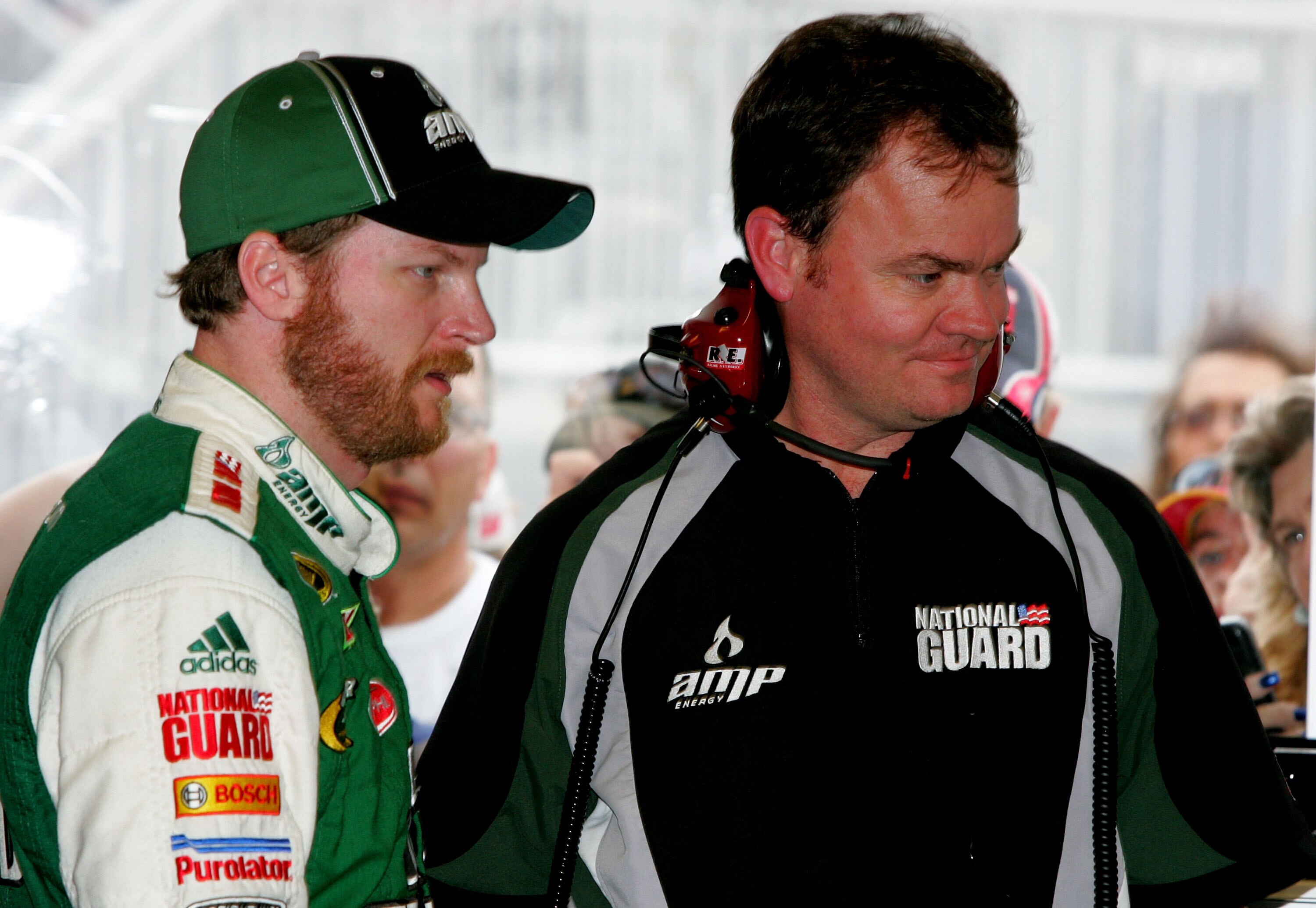 DAYTONA BEACH, FL - FEBRUARY 05:  Dale Earnhardt Jr., driver of the #88 AMP Energy Chevrolet, stands in the garage with crew chief Lance McGrew during practice for the NASCAR Sprint Cup Series Daytona 500 at Daytona International Speedway on February 5, 2