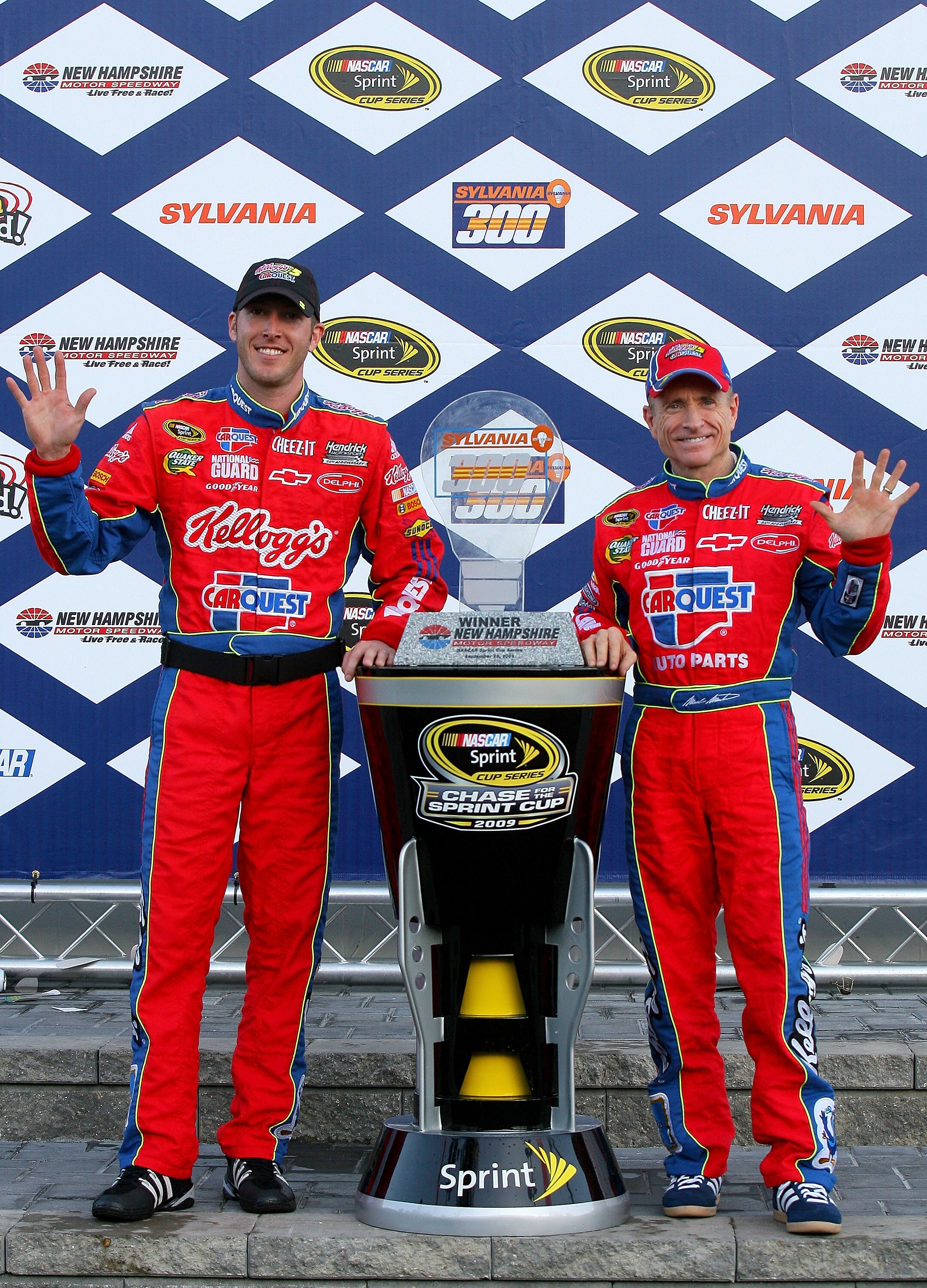 LOUDON, NH - SEPTEMBER 20:  Mark Martin (R), driver of the #5 CARQUEST/Kellogg's Chevrolet, and crew chief Alan Gustafson celebrates with the trophy in victory lane after winning the NASCAR Sprint Cup Series Sylvania 300 at the New Hampshire Motor Speedwa