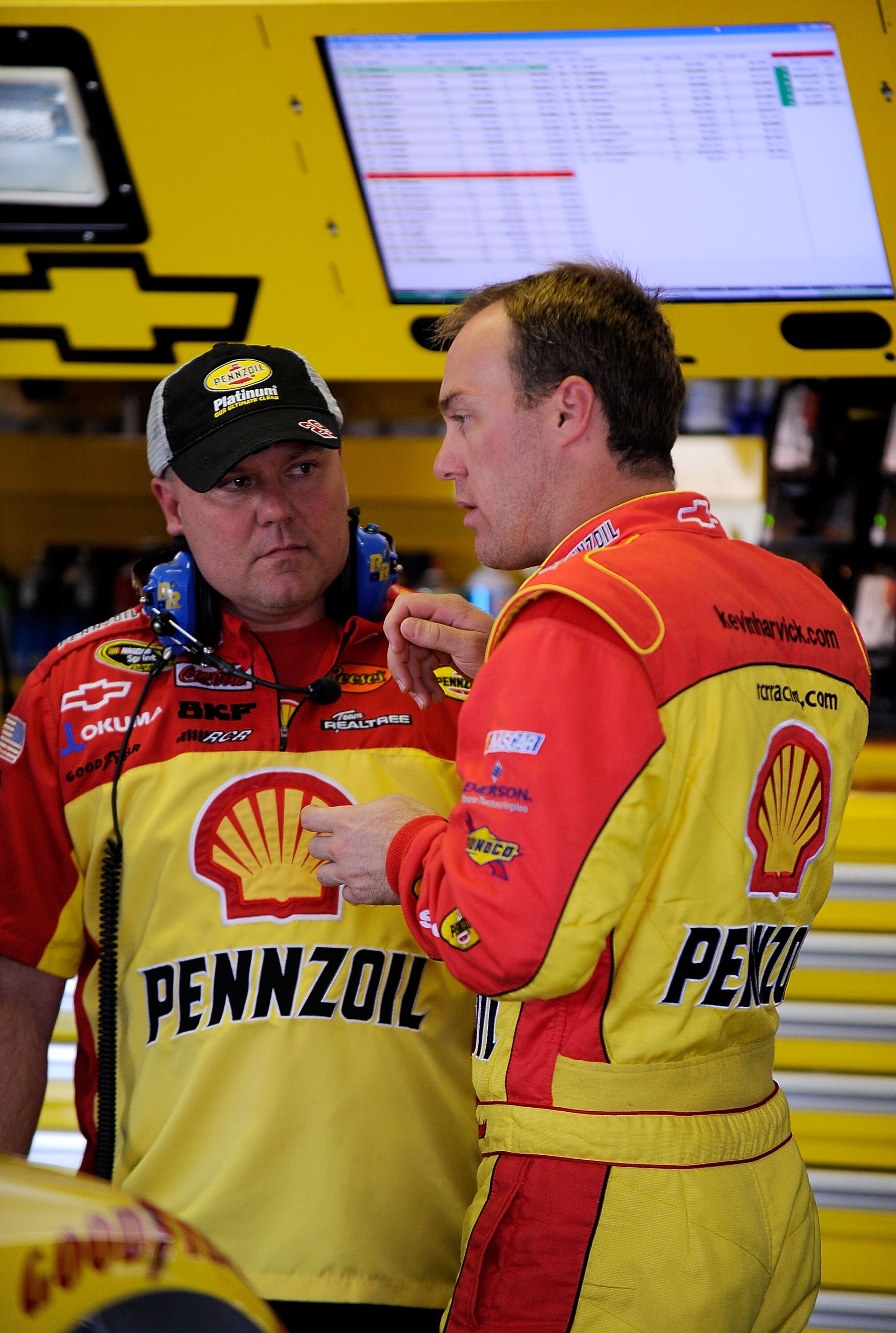 LONG POND, PA - JUNE 04:  Kevin Harvick (R), driver of the #29 Shell/Pennzoil Chevrolet, talks with a crew chief Gil Martin in the garage prior to practice for the NASCAR Sprint Cup Series Gillette Fusion ProGlide 500 at Pocono Raceway on June 4, 2010 in