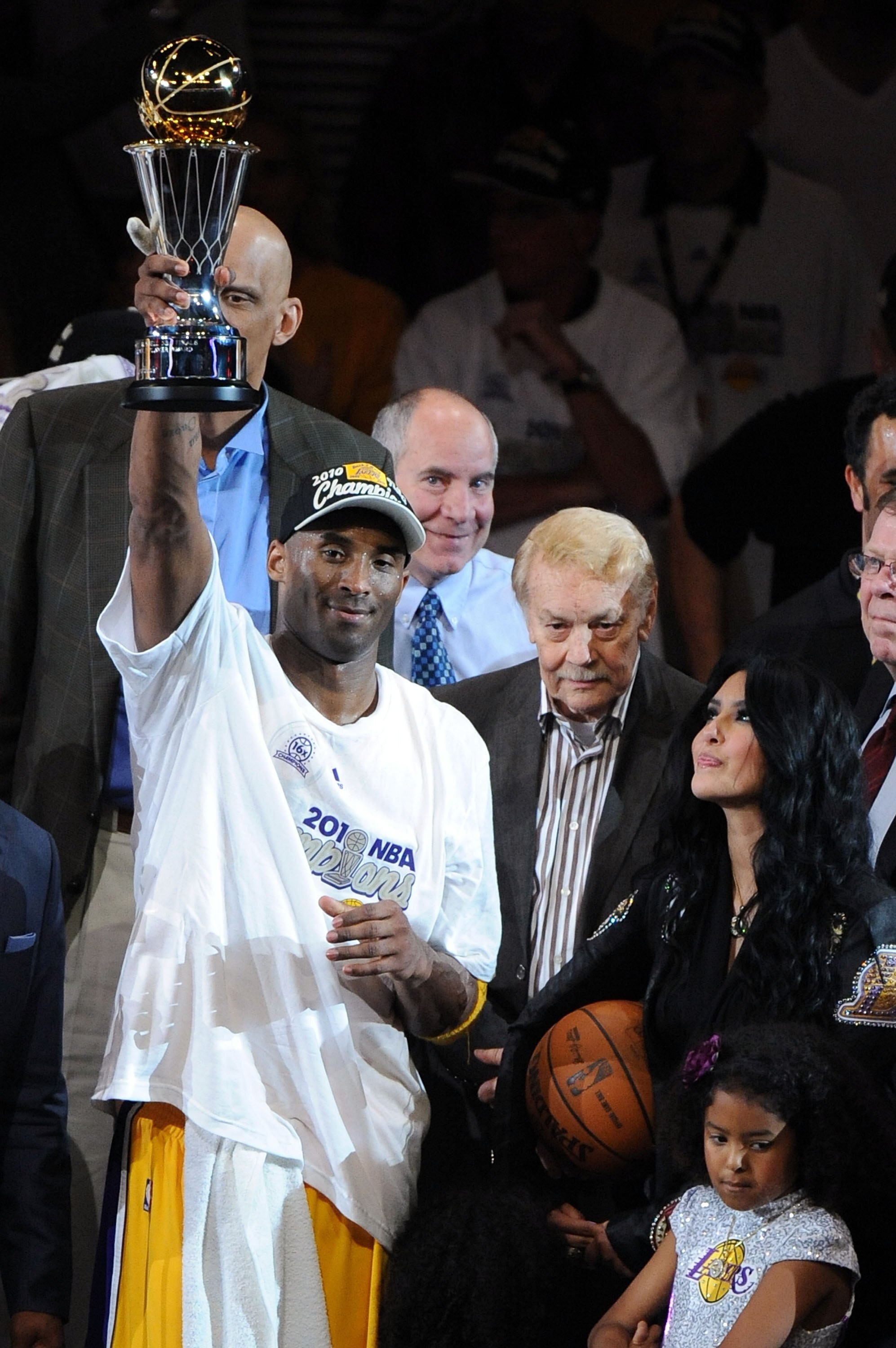 LOS ANGELES, CA - JUNE 17:  Kobe Bryant #24 of the Los Angeles Lakers holds up the Bill Russell Finals MVP trophy alongside team owner Dr. Jerry Buss and Bryant's wife Vanessa after the Lakers defeated the Boston Celtics 83-79 in Game Seven of the 2010 NB