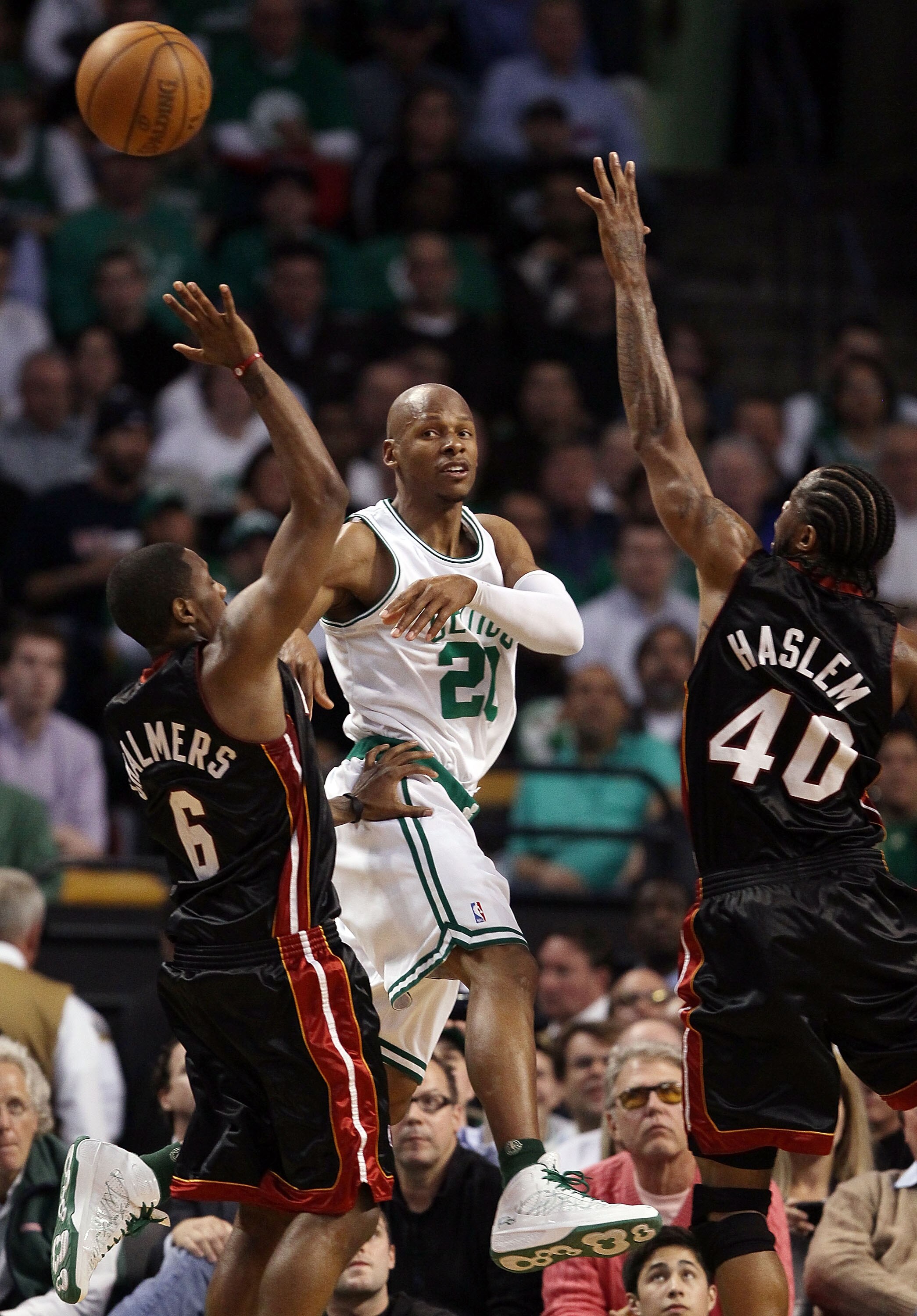 BOSTON - APRIL 27:  Ray Allen #20 of the Boston Celtics passes the ball under pressure from Mario Chalmers #6 and Udonis Haslem #40 of the Miami Heat during Game Five of the Eastern Conference Quarterfinals of the 2010 NBA playoffs at the TD Garden on Apr