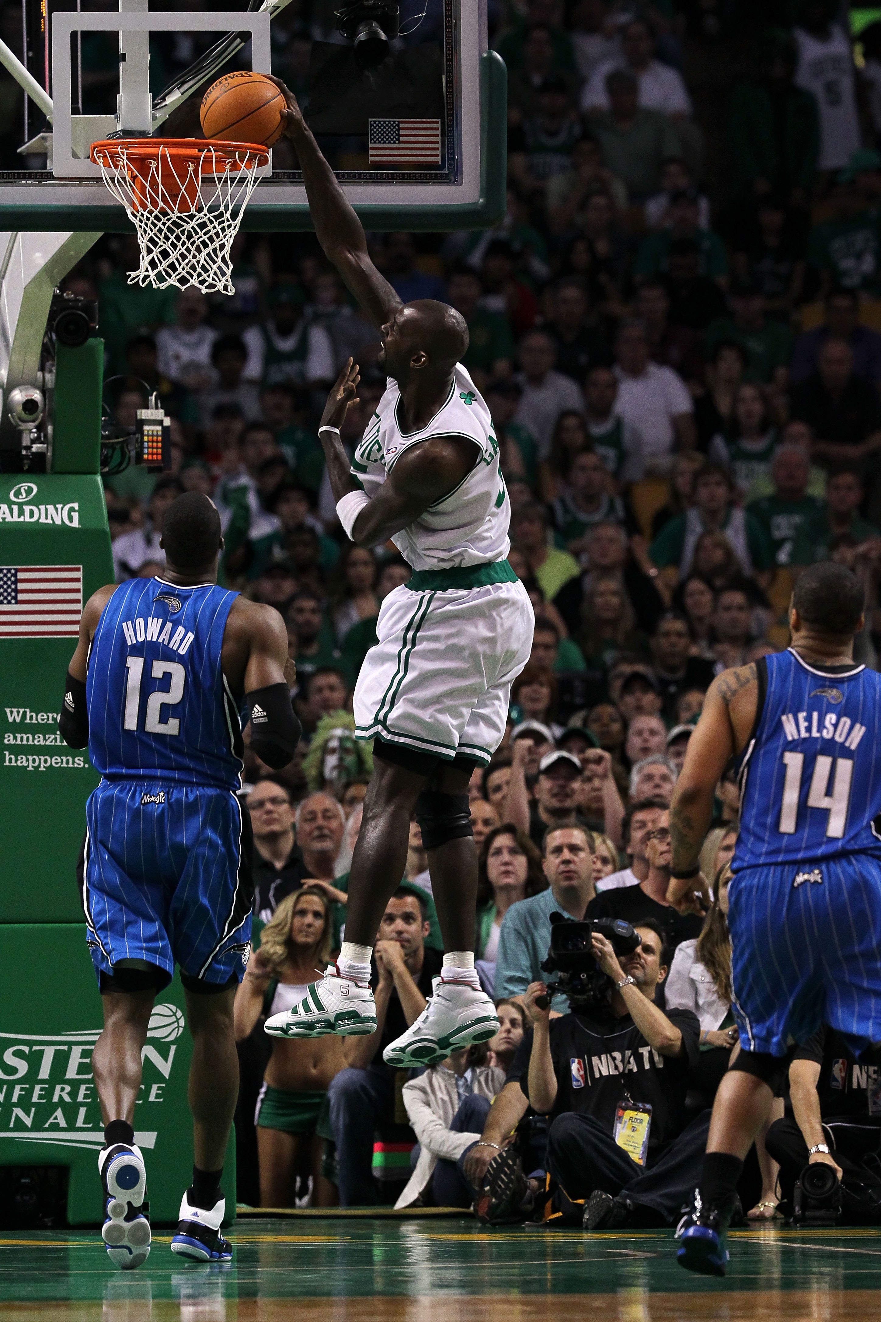 BOSTON - MAY 28:  Kevin Garnett #5 of the Boston Celtics dunks against Dwight Howard #12 of the Orlando Magic in Game Six of the Eastern Conference Finals during the 2010 NBA Playoffs at TD Garden on May 28, 2010 in Boston, Massachusetts.  NOTE TO USER: U