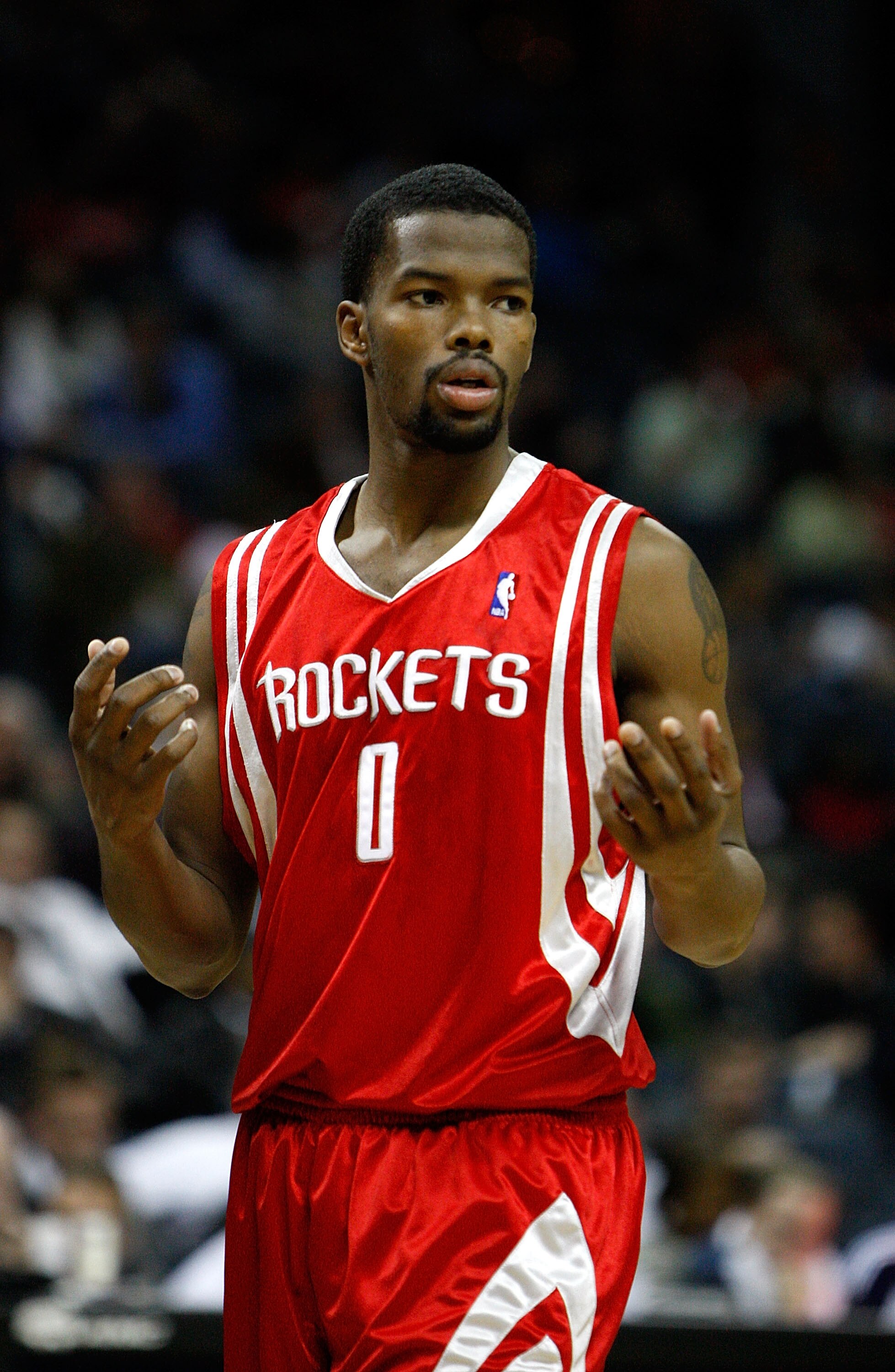 CHARLOTTE, NC - JANUARY 12:  Aaron Brooks #0 of the Houston Rockets reacts to his team against the Charlotte Bobcats at Time Warner Cable Arena on January 12, 2010 in Charlotte, North Carolina.  NOTE TO USER: User expressly acknowledges and agrees that, b