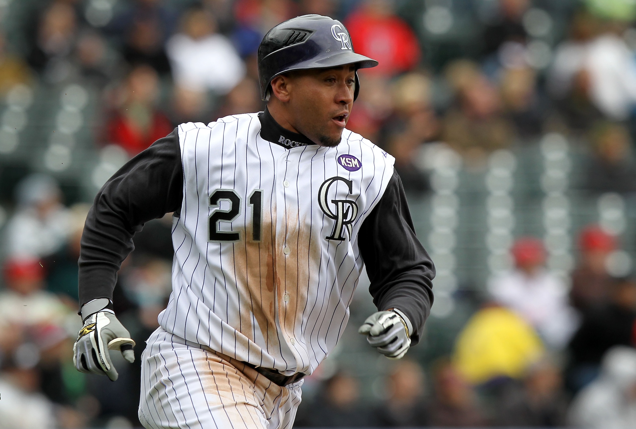 DENVER - MAY 12: Catcher Miguel Olivo #21 of the Colorado Rockies heads for second on a ground rule double in the fourth inning as he went 5 for 5 including the game winning homerun against the Philadelphia Phillies in the 10th inning at Coors Field on M DENVER - MAY 12: Catcher Miguel Olivo #21 of the Colorado Rockies heads for second on a ground rule double in the fourth inning as he went 5 for 5 including the game winning homerun against the Philadelphia Phillies in the 10th inning at Coors Field on M