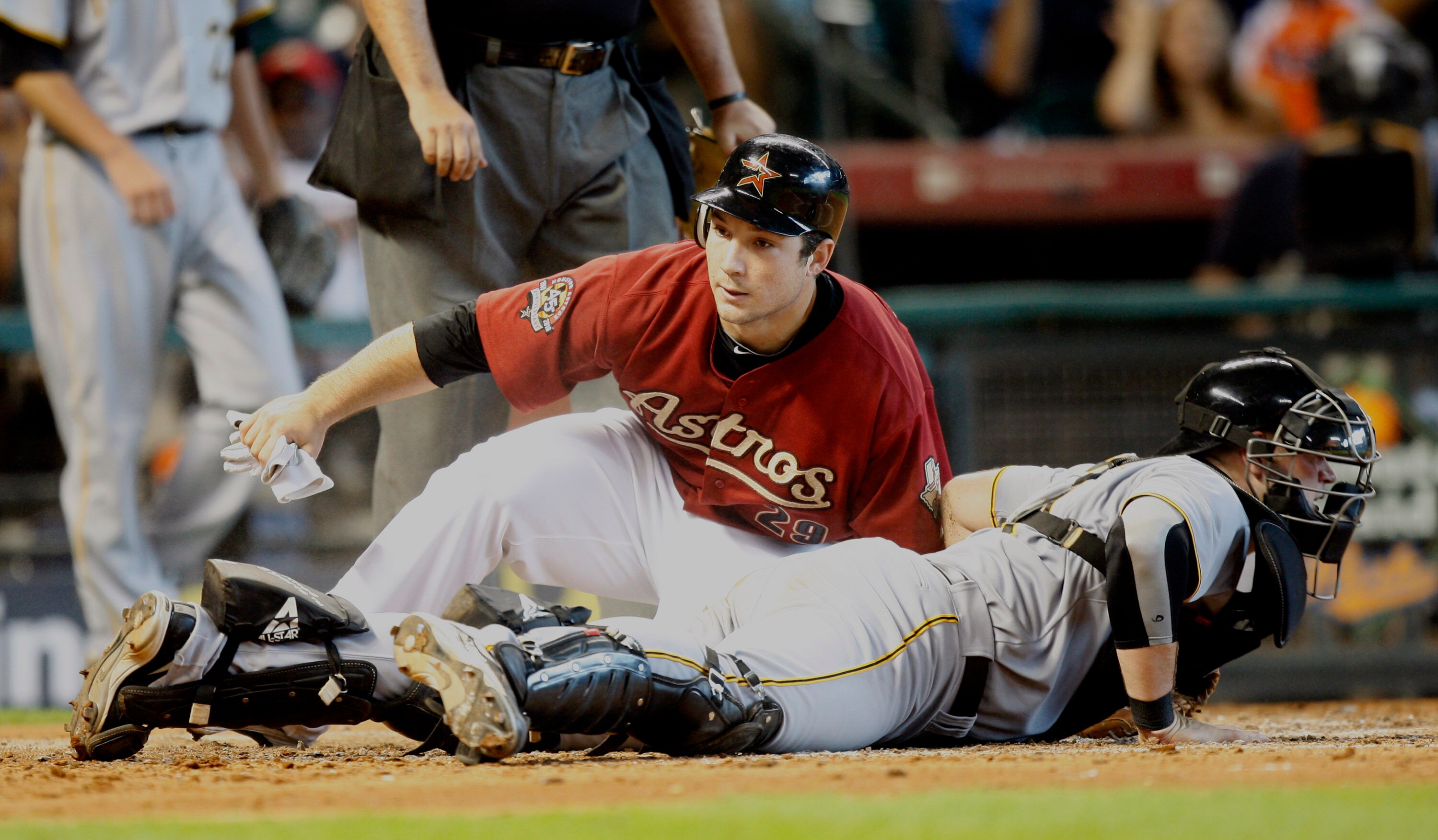 HOUSTON - AUGUST 15:  Brett Wallace #29 of the Houston Astros slides safely into home plate as catcher Chris Snyder #19 of the Pittsburgh Pirates looks around at Minute Maid Park on August 15, 2010 in Houston, Texas.  (Photo by Bob Levey/Getty Images)